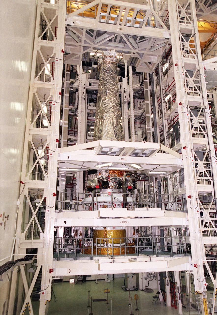 In the Vertical Processing Facility, the Chandra X-ray Observatory is revealed with its protective cover removed. Chandra is ready for mating with the Inertial Upper Stage (IUS) beneath it, to be followed by testing to validate the IUS/Chandra connections and to check the orbiter avionics interfaces. Following that, an end-to-end test (ETE) will be conducted to verify the communications path to Chandra, commanding it as if it were in space. With the world's most powerful X-ray telescope, Chandra will allow scientists from around the world to see previously invisible black holes and high-temperature gas clouds, giving the observatory the potential to rewrite the books on the structure and evolution of our universe. Chandra is scheduled for launch July 22 aboard Space Shuttle Columbia, on mission STS-93