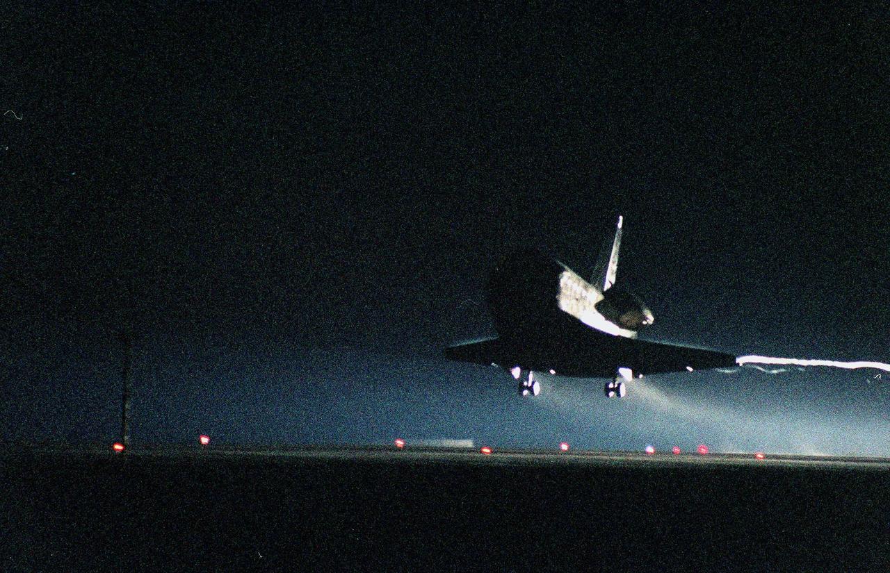 KENNEDY SPACE CENTER, Fla. -- With a contrail streaming off its wing, the Space Shuttle orbiter Discovery nears touchdown on KSC's Shuttle Landing Facility Runway 15 to complete the 9-day, 19-hour, 13-minute and 1-second long STS-96 mission. Main gear touchdown was at 2:02:43 a.m. EDT June 6 , landing on orbit 154 of the mission. Nose gear touchdown was at 2:02:59 a.m., and the wheels stopped at 2:03:39 a.m. At the controls are Commander Kent V. Rominger and Pilot Rick D. Husband. Also onboard the orbiter are Mission Specialists Ellen Ochoa (Ph.D.), Tamara E. Jernigan (Ph.D.), Daniel T. Barry (M.D., Ph.D.), Julie Payette and Valery Ivanovich Tokarev. Payette represents the Canadian Space Agency and Tokarev the Russian Space Agency. The crew are returning from the second flight to the International Space Station on a logistics and resupply mission. This was the 94th flight in the Space Shuttle program and the 26th for Discovery, also marking the 47th at KSC, the 24th in the last 25 missions, 11th at night, and the 18th consecutive landing in Florida