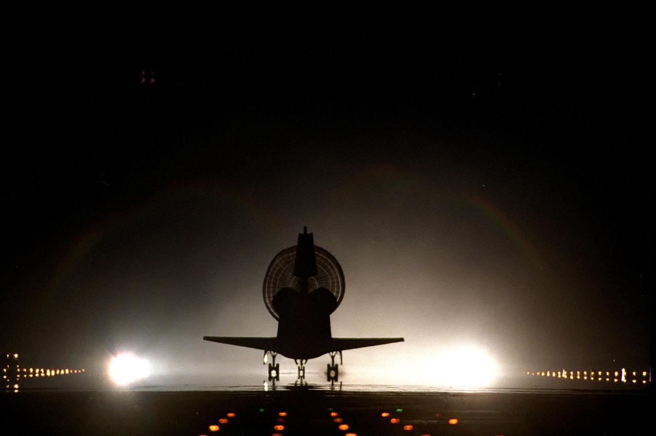KENNEDY SPACE CENTER, Fla. -- With its drag chute fully deployed, Space Shuttle Discovery lands on KSC's brightly lighted Shuttle Landing Facility runway 15, completing the 9-day, 19-hour, 13-minute and 1-second long STS-96 mission. Main gear touchdown was at 2:02:43 a.m. EDT June 6 , landing on orbit 154 of the mission. Nose gear touchdown was at 2:02:59 a.m., and the wheels stopped at 2:03:39 a.m. At the controls were Commander Kent V. Rominger and Pilot Rick D. Husband. Also onboard the orbiter were Mission Specialists Ellen Ochoa (Ph.D.), Tamara E. Jernigan (Ph.D.), Daniel T. Barry (M.D., Ph.D.), Julie Payette and Valery Ivanovich Tokarev. Payette represents the Canadian Space Agency and Tokarev the Russian Space Agency. The crew returned from the second flight to the International Space Station on a logistics and resupply mission. This was the 94th flight in the Space Shuttle program and the 26th for Discovery, also marking the 47th landing at KSC, the 24th in the last 25 missions, 11th at night, and the 18th consecutive landing in Florida
