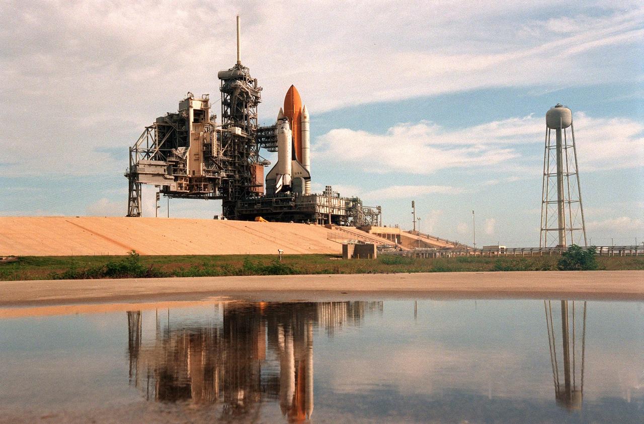 KENNEDY SPACE CENTER, FLA. -- Space Shuttle Columbia sits on Launch Pad 39B less than two weeks after liftoff of Discovery on mission STS-96. Columbia was rolled out June 7 in preparation for the launch of STS-93 with its payload of the Chandra X-ray Observatory. The Rotating Service Structure, at left, will be moved into place on Tuesday, June 8. With the world's most powerful X-ray telescope, Chandra will allow scientists from around the world to see previously invisible black holes and high-temperature gas clouds, giving the observatory the potential to rewrite the books on the structure and evolution of our universe. Columbia (OV-102) is the first of NASA's orbiter fleet, delivered to Kennedy Space Center in March 1979. Columbia initiated the Space Shuttle flight program at KSC when it lifted off Launch Pad 39A on April 12, 1981