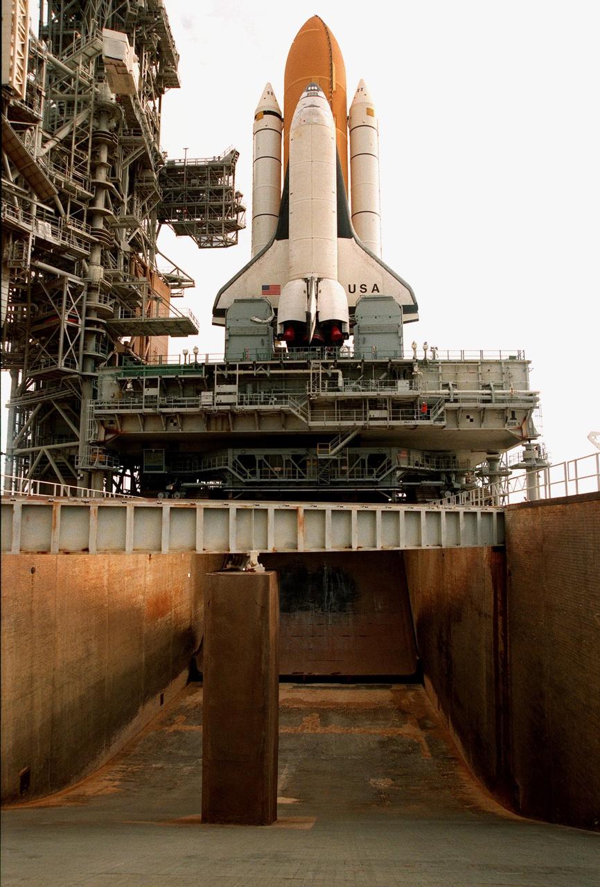 KENNEDY SPACE CENTER, FLA. -- Space Shuttle Columbia sits on Launch Pad 39B in preparation for the launch of STS-93. This view shows the flame trench, 490 feet long and 40 feet high, which helps contain the intense heat that occurs at launch. Columbia was rolled out June 7, less than two weeks after the liftoff of Discovery on mission STS-96. The STS-93 payload is the Chandra X-ray Observatory, the world's most powerful X-ray telescope, which will allow scientists from around the world to see previously invisible black holes and high-temperature gas clouds, giving the observatory the potential to rewrite the books on the structure and evolution of our universe. Columbia (OV-102) is the first of NASA's orbiter fleet, delivered to Kennedy Space Center in March 1979. Columbia initiated the Space Shuttle flight program at KSC when it lifted off Launch Pad 39A on April 12, 1981