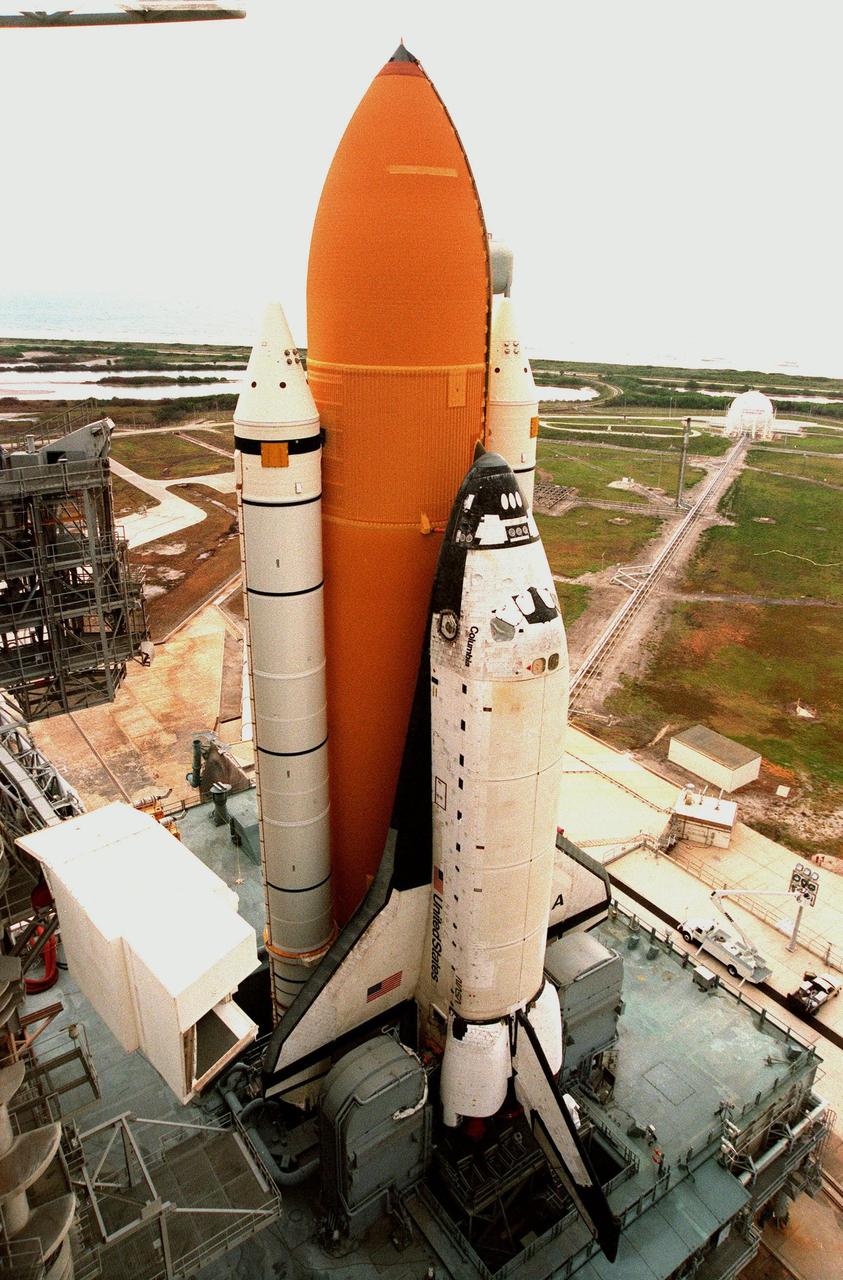 KENNEDY SPACE CENTER, FLA. -- Space Shuttle Columbia sits on Launch Pad 39B less than two weeks after liftoff of Discovery on mission STS-96. Columbia was rolled out June 7 in preparation for the launch of STS-93 with its payload of the Chandra X-ray Observatory. The Rotating Service Structure will be moved into place around it on Tuesday, June 8. With the world's most powerful X-ray telescope, Chandra will allow scientists from around the world to see previously invisible black holes and high-temperature gas clouds, giving the observatory the potential to rewrite the books on the structure and evolution of our universe. Columbia (OV-102) is the first of NASA's orbiter fleet, delivered to Kennedy Space Center in March 1979. Columbia initiated the Space Shuttle flight program at KSC when it lifted off Launch Pad 39A on April 12, 1981