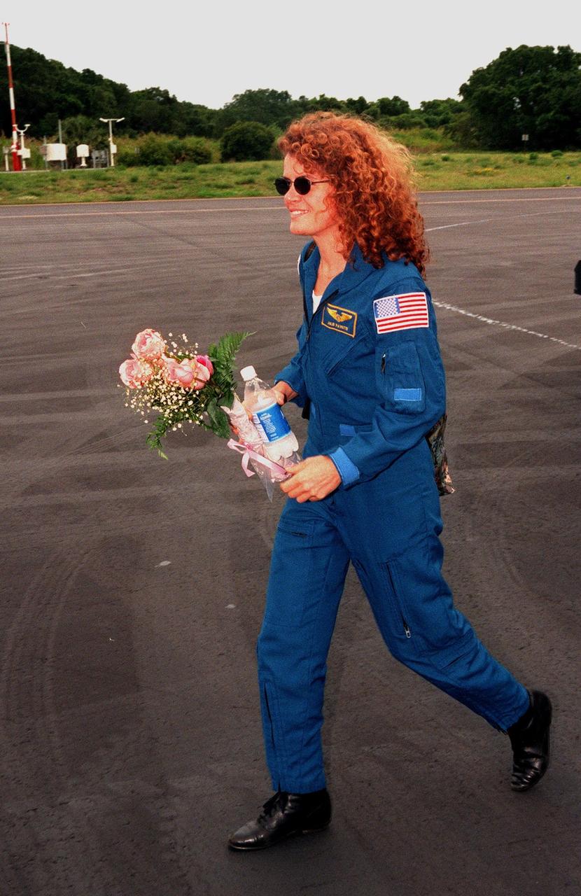 STS-96 Mission Specialist Julie Payette, who is with the Canadian Space Agency, heads for a plane at the Cape Canaveral Air Station Skid Strip for her return to the Johnson Space Center in Houston, Texas. Other crew members also returning are Commander Kent V. Rominger, Pilot Rick D. Husband, and Mission Specialists Ellen Ochoa (Ph.D.), Tamara E. Jernigan (Ph.D.), Daniel T. Barry (M.D., Ph.D.) and Valery Ivanovich Tokarev, with the Russian Space Agency. After a successful 10-day mission to the International Space Station aboard Space Shuttle Discovery, the STS-96 crew landed June 6 at 2:02:43 a.m. EDT, in the 11th night landing at KSC