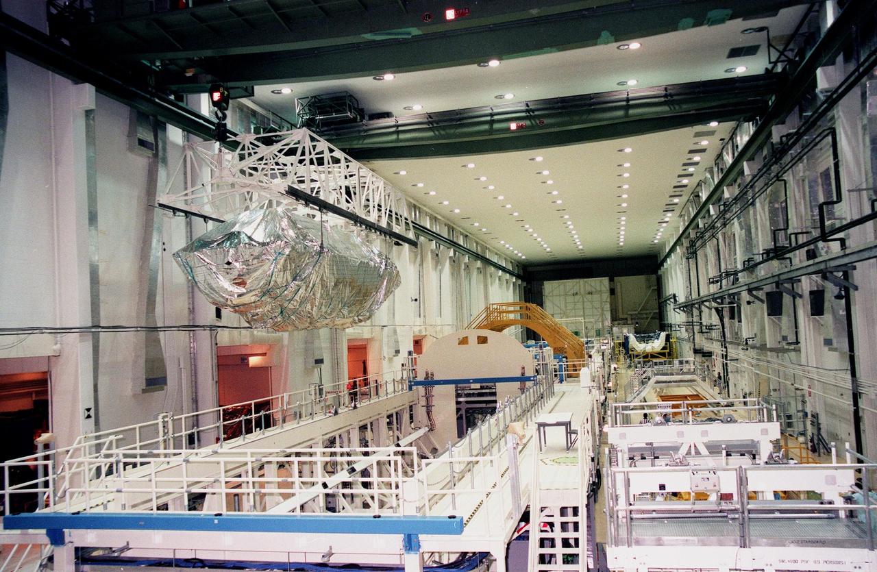 KENNEDY SPACE CENTER, FLA. -- In the Operations and Checkout Bldg. (O&C), an overhead crane moves the S0 truss segment toward a workstand.  The S0 truss will undergo processing in the O&C during which the Canadian Mobile Transporter, power distribution system modules, a heat pipe radiator for cooling, computers and a pair of rate gyroscopes will be installed.  Four Global Positioning System antennas are already installed.  A 44- by 15-foot structure weighing 30,800 pounds when fully outfitted and ready for launch, the truss will be at the center of the ISS 10-truss, girderlike structure that will ultimately extend the length of a football field.  Eventually the S0 truss will be attached to the U.S. Lab, "Destiny," which is scheduled to be added to the ISS in April 2000.  Later, other trusses will be attached to the S0 on orbit.  The S0 truss is scheduled to be launched in the first quarter of 2001 on mission STS-108