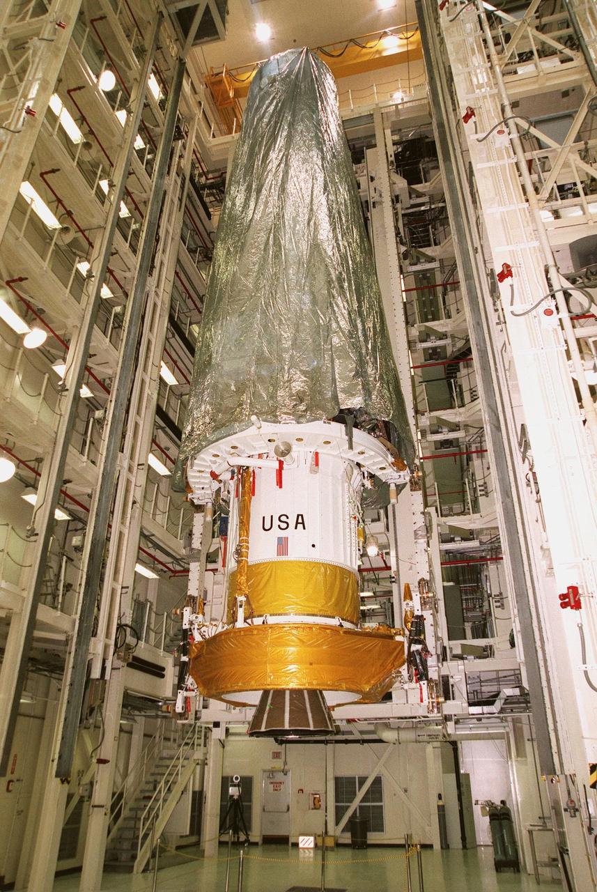 Inside the Vertical Processing Facility, the Chandra X-ray Observatory is lifted by an overhead crane in order to transfer it into the payload canister transporter and out to Launch Pad 39B. Chandra is scheduled to launch no earlier than July 20 at 12:36 a.m. EDT aboard Space Shuttle Columbia, on mission STS-93. With the world's most powerful X-ray telescope, Chandra will allow scientists from around the world to see previously invisible black holes and high-temperature gas clouds, giving the observatory the potential to rewrite the books on the structure and evolution of our universe