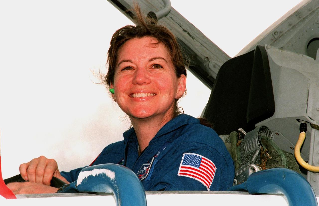 STS-93 Mission Specialist Catherine G. Coleman (Ph.D.) grins on her arrival at KSC's Shuttle Landing Facility aboard a T-38 jet to participate in Terminal Countdown Demonstration Tests (TCDT) this week. TCDT activities familiarize the crew with the mission, provide training in emergency exit from the orbiter and launch pad, and include a launch-day dress rehearsal culminating with a simulated main engine cut-off. Joining Coleman are Commander Eileen M. Collins, Pilot Jeffrey S. Ashby and Mission Specialists Steven A. Hawley (Ph.D.) and Michel Tognini of France, who is with the Centre National d'Etudes Spatiales (CNES). Collins is the first woman to serve as mission commander. The primary mission of STS-93 is the release of the Chandra X-ray Observatory, which will allow scientists from around the world to obtain unprecedented X-ray images of exotic environments in space to help understand the structure and evolution of the universe. Chandra is expected to provide unique and crucial information on the nature of objects ranging from comets in our solar system to quasars at the edge of the observable universe. Since X-rays are absorbed by the Earth's atmosphere, space-based observatories are necessary to study these phenomena and allow scientists to analyze some of the greatest mysteries of the universe