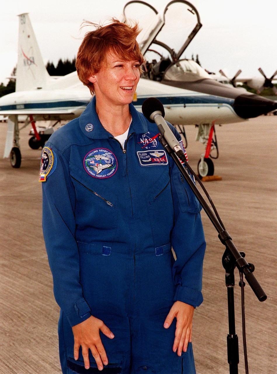 STS-93 Commander Eileen M. Collins talks to the media after arriving at KSC's Shuttle Landing Facility to participate in Terminal Countdown Demonstration Tests (TCDT) this week. TCDT activities familiarize the crew with the mission, provide training in emergency exit from the orbiter and launch pad, and include a launch-day dress rehearsal culminating with a simulated main engine cut-off. Collins is the first woman to serve as mission commander. Joining Collins are Pilot Jeffrey S. Ashby and Mission Specialists Steven A. Hawley (Ph.D.), Catherine G. Coleman (Ph.D.) and Michel Tognini of France, with the Centre National d'Etudes Spatiales (CNES). The primary mission of STS-93 is the release of the Chandra X-ray Observatory, which will allow scientists from around the world to obtain unprecedented X-ray images of exotic environments in space to help understand the structure and evolution of the universe. Chandra is expected to provide unique and crucial information on the nature of objects ranging from comets in our solar system to quasars at the edge of the observable universe. Since X-rays are absorbed by the Earth's atmosphere, space-based observatories are necessary to study these phenomena and allow scientists to analyze some of the greatest mysteries of the universe