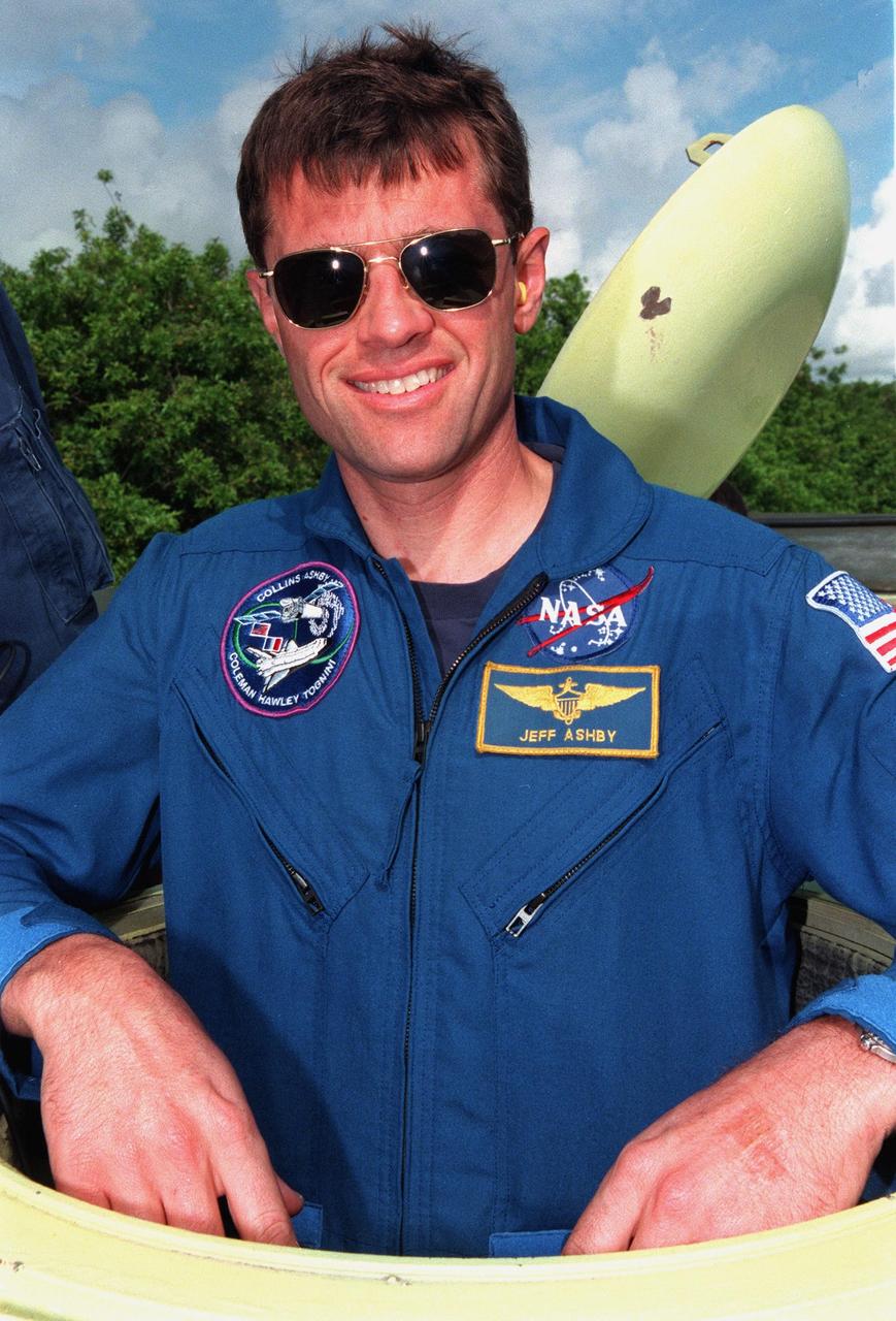 STS-93 Pilot Jeffrey S. Ashby pauses for the photographer before climbing into an M-113 armored personnel carrier at the launch pad to take part in emergency egress training. In preparation for their mission, the STS-93 crew are participating in Terminal Countdown Demonstration Test activities that also include a launch-day dress rehearsal culminating with a simulated main engine cut-off. Others in the crew are Commander Eileen M. Collins and Mission Specialists Steven A. Hawley (Ph.D.), Catherine G. Coleman (Ph.D.), and Michel Tognini of France, who represents the Centre National d'Etudes Spatiales (CNES). Collins is the first woman to serve as a mission commander. The primary mission of STS-93 is the release of the Chandra X-ray Observatory, which will allow scientists from around the world to obtain unprecedented X-ray images of exotic environments in space to help understand the structure and evolution of the universe. Chandra is expected to provide unique and crucial information on the nature of objects ranging from comets in our solar system to quasars at the edge of the observable universe. Since X-rays are absorbed by the Earth's atmosphere, space-based observatories are necessary to study these phenomena and allow scientists to analyze some of the greatest mysteries of the universe. The targeted launch date for STS-93 is no earlier than July 20 at 12:36 a.m. EDT from Launch Pad 39B