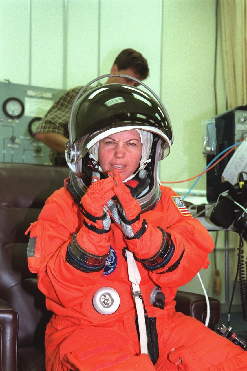 In the Operations and Checkout Bldg., STS-93 Mission Specialist Catherine G. Coleman (Ph.D.) checks out her launch and entry suit. In preparation for their mission, the STS-93 crew are participating in Terminal Countdown Demonstration Test activities that also include equipment check and a launch-day dress rehearsal culminating with a simulated main engine cut-off. Others in the crew participating are Commander Eileen M. Collins, Pilot Jeffrey S. Ashby, Mission Specialist Steven A. Hawley (Ph.D.) and Michel Tognini of France, who represents the Centre National d'Etudes Spatiales (CNES). Collins is the first woman to serve as a Shuttle commander. The primary mission of STS-93 is the release of the Chandra X-ray Observatory, which will allow scientists from around the world to obtain unprecedented X-ray images of exotic environments in space to help understand the structure and evolution of the universe. The targeted launch date for STS-93 is no earlier than July 20 at 12:36 a.m. EDT from Launch Pad 39B