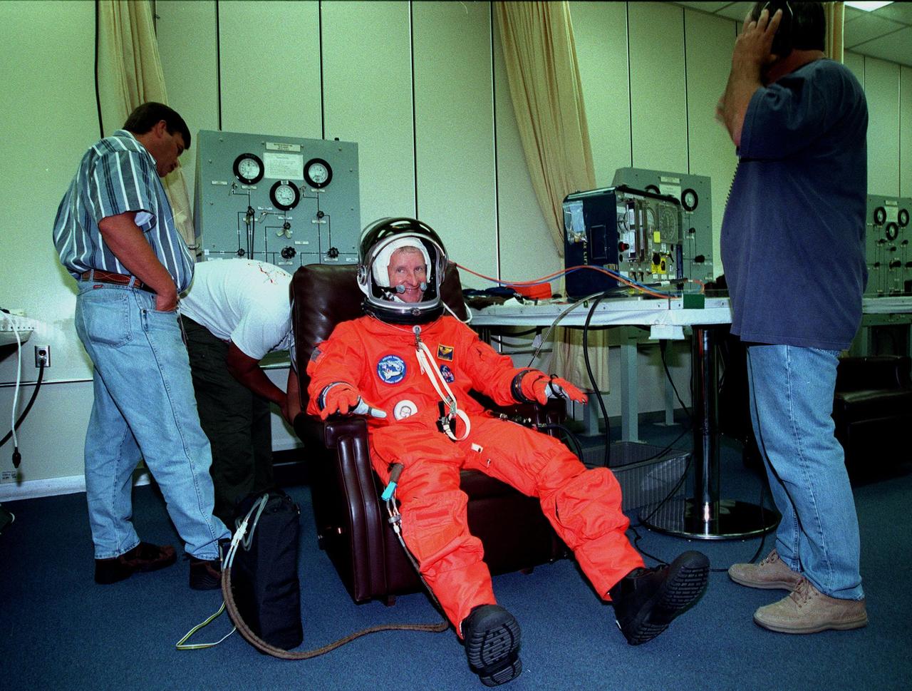 In the Operations and Checkout Bldg., Mission Specialist Steven A. Hawley (Ph.D.) has his launch and entry suit checked by technicians. In preparation for their mission, the STS-93 crew are participating in Terminal Countdown Demonstration Test activities that also include equipment check and a launch-day dress rehearsal culminating with a simulated main engine cut-off. Others in the crew participating are Commander Eileen M. Collins, Pilot Jeffrey S. Ashby, and Mission Specialists Catherine G. Coleman (Ph.D.) and Michel Tognini of France, who represents the Centre National d'Etudes Spatiales (CNES). Collins is the first woman to serve as a Shuttle commander. The primary mission of STS-93 is the release of the Chandra X-ray Observatory, which will allow scientists from around the world to obtain unprecedented X-ray images of exotic environments in space to help understand the structure and evolution of the universe. The targeted launch date for STS-93 is no earlier than July 20 at 12:36 a.m. EDT from Launch Pad 39B