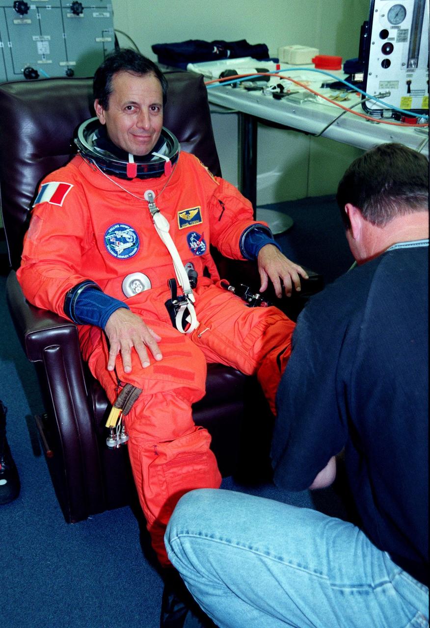 STS-93 Mission Specialist Michel Tognini of France, who represents the Centre National d'Etudes Spatiales (CNES), has his launch and entry suit checked by a technician in the Operations and Checkout Bldg. In preparation for their mission, the STS-93 crew are participating in Terminal Countdown Demonstration Test activities that also include equipment check and a launch-day dress rehearsal culminating with a simulated main engine cut-off. Others in the crew participating are Commander Eileen M. Collins, Pilot Jeffrey S. Ashby, and Mission Specialists Steven A. Hawley (Ph.D.) and Catherine G. Coleman (Ph.D.). Collins is the first woman to serve as a Shuttle commander. The primary mission of STS-93 is the release of the Chandra X-ray Observatory, which will allow scientists from around the world to obtain unprecedented X-ray images of exotic environments in space to help understand the structure and evolution of the universe. The targeted launch date for STS-93 is no earlier than July 20 at 12:36 a.m. EDT from Launch Pad 39B
