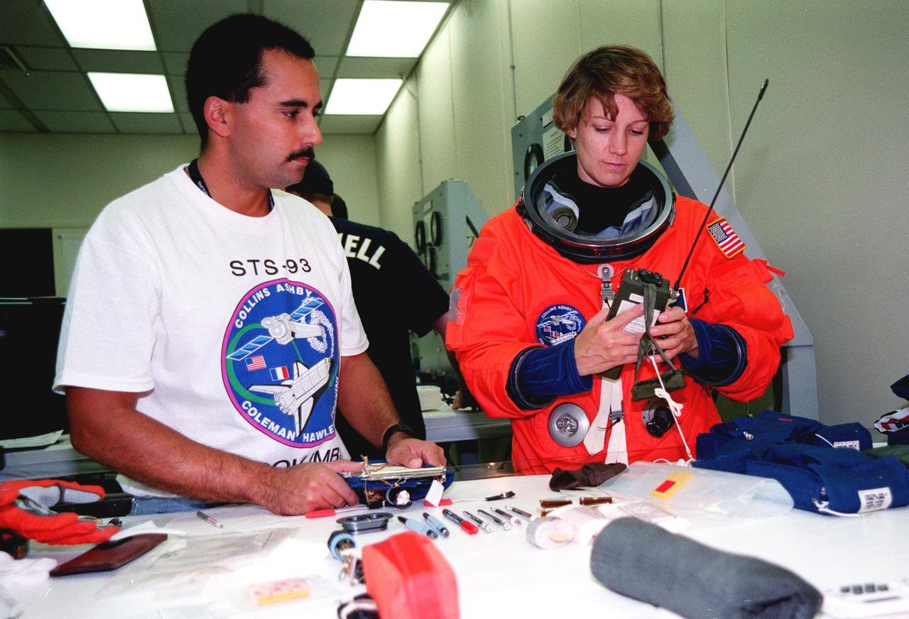 In the Operations and Checkout Bldg., STS-93 Commander Eileen M. Collins checks out a PRC-112 survival radio, part of flight equipment, under the eye of Ray Cuevas, with United Space Alliance. In preparation for their mission, the STS-93 crew are participating in Terminal Countdown Demonstration Test activities that also include equipment check and a launch-day dress rehearsal culminating with a simulated main engine cut-off. Others in the crew participating are Pilot Jeffrey S. Ashby, and Mission Specialists Steven A. Hawley (Ph.D.), Catherine G. Coleman (Ph.D.), and Michel Tognini of France, who represents the Centre National d'Etudes Spatiales (CNES). Collins is the first woman to serve as a Shuttle commander. The primary mission of STS-93 is the release of the Chandra X-ray Observatory, which will allow scientists from around the world to obtain unprecedented X-ray images of exotic environments in space to help understand the structure and evolution of the universe. The targeted launch date for STS-93 is no earlier than July 20 at 12:36 a.m. EDT from Launch Pad 39B