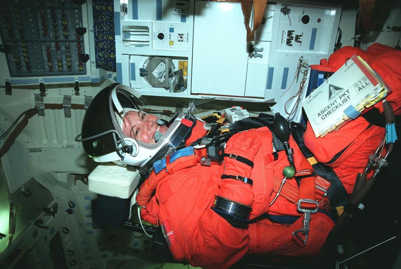 STS-93 Catherine G. Coleman (Ph.D.) sits inside the orbiter Columbia during Terminal Countdown Demonstration Test (TCDT) activities that include emergency exit training and a launch-day dress rehearsal culminating with a simulated main engine cut-off. Other crew members participating are Commander Eileen M. Collins, Pilot Jeffrey S. Ashby, and Mission Specialists Steven A. Hawley (Ph.D.) and Michel Tognini of France, who represents the Centre National d'Etudes Spatiales (CNES). Collins is the first woman to serve as a Shuttle commander. The primary mission of STS-93 is the release of the Chandra X-ray Observatory, which will allow scientists from around the world to obtain unprecedented X-ray images of exotic environments in space to help understand the structure and evolution of the universe. The targeted launch date for STS-93 is no earlier than July 20 at 12:36 a.m. EDT from Launch Pad 39B