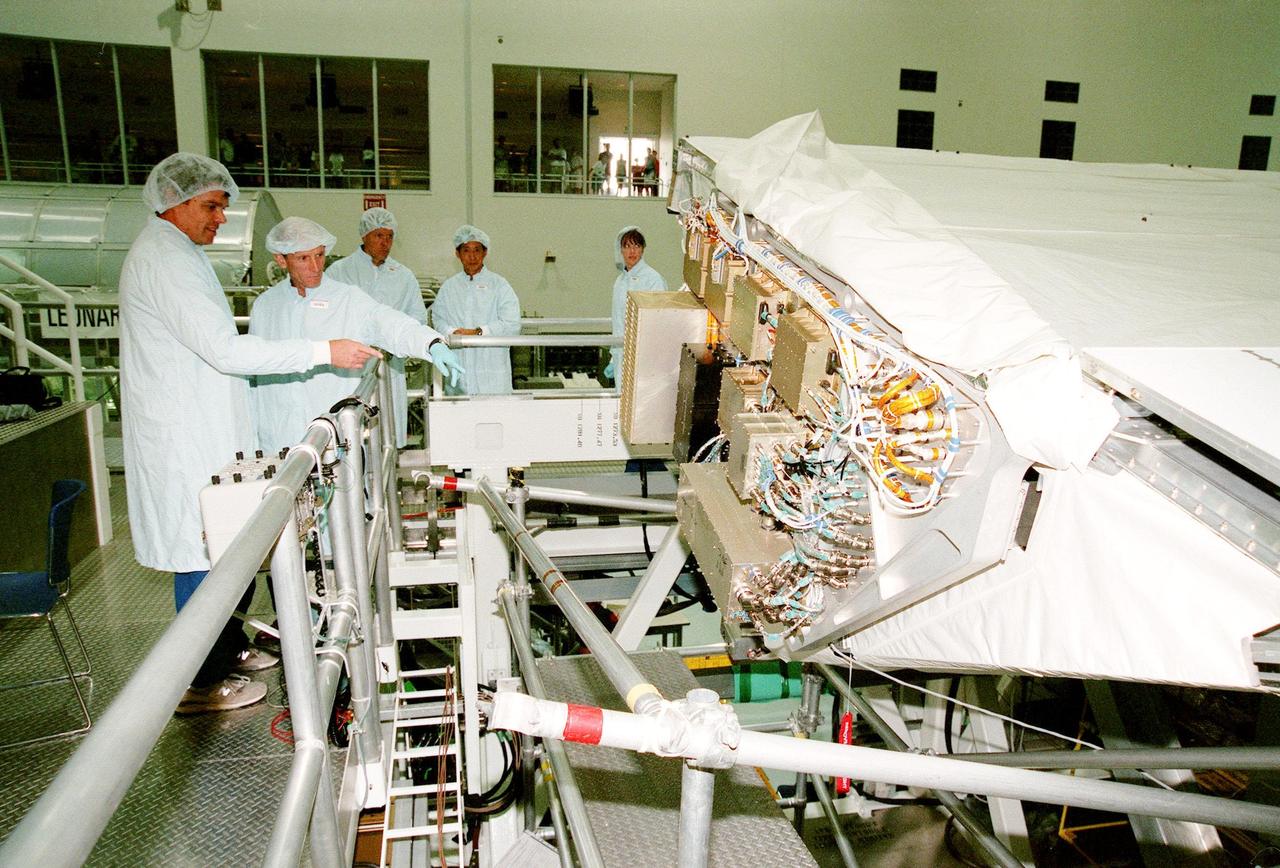 In the Space Station Processing Facility, the STS-99 crew looks over the payload for their mission, the Shuttle Radar Topography Mission (SRTM). Pointing to the SRTM are Commander Kevin R. Kregel and Mission Specialist Gerhard Thiele of Germany. Behind them are (left to right) Pilot Dominic L. Pudwill Gorie and Mission Specialists Mamoru Mohri of Japan and Janet Lynn Kavandi (Ph.D.) The remaining crew member (not shown) is Mission Specialist Janice Voss (Ph.D.) Mohri represents the National Space Development Agency of Japan and Thiele represents the European Space Agency. An international project spearheaded by the National Imagery and Mapping Agency and NASA, with participation of the German Aerospace Center DLR, the SRTM consists of a specially modified radar system that will gather data for the most accurate and complete topographic map of the Earth's surface that has ever been assembled. SRTM will make use of radar interferometry, wherein two radar images are taken from slightly different locations. Differences between these images allow for the calculation of surface elevation, or change. The SRTM hardware will consist of one radar antenna in the shuttle payload bay and a second radar antenna attached to the end of a mast extended 60 meters (195 feet) out from the shuttle. STS-99 is scheduled to launch Sept. 16 at 8:47 a.m. from Launch Pad 39A