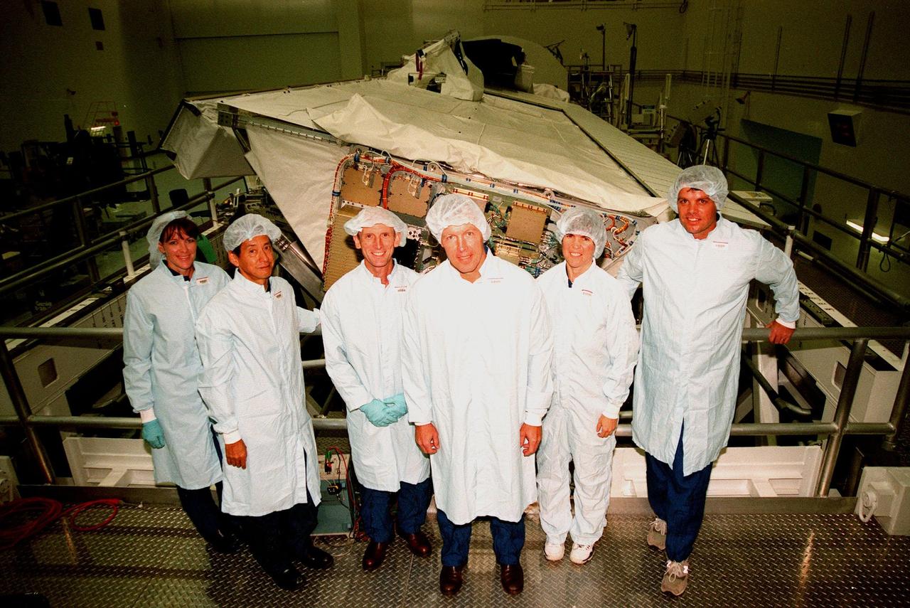 The STS-99 crew poses in front of the Shuttle Radar Topography Mission (SRTM) in the Space Station Processing Facility. The crew has been checking out the SRTM, which is the payload for their mission. From left are Mission Specialists Janet Lynn Kavandi (Ph.D.), Mamoru Mohri of Japan, and Gerhard Thiele of Germany; Pilot Dominic L. Pudwill Gorie; Mission Specialist Janice Voss (Ph.D.); and Commander Kevin R. Kregel. Mohri represents the National Space Development Agency of Japan and Thiele represents the European Space Agency. An international project spearheaded by the National Imagery and Mapping Agency and NASA, with participation of the German Aerospace Center DLR, the SRTM consists of a specially modified radar system that will gather data for the most accurate and complete topographic map of the Earth's surface that has ever been assembled. SRTM will make use of radar interferometry, wherein two radar images are taken from slightly different locations. Differences between these images allow for the calculation of surface elevation, or change. The SRTM hardware will consist of one radar antenna in the shuttle payload bay and a second radar antenna attached to the end of a mast extended 60 meters (195 feet) out from the shuttle. STS-99 is scheduled to launch Sept. 16 at 8:47 a.m. from Launch Pad 39A