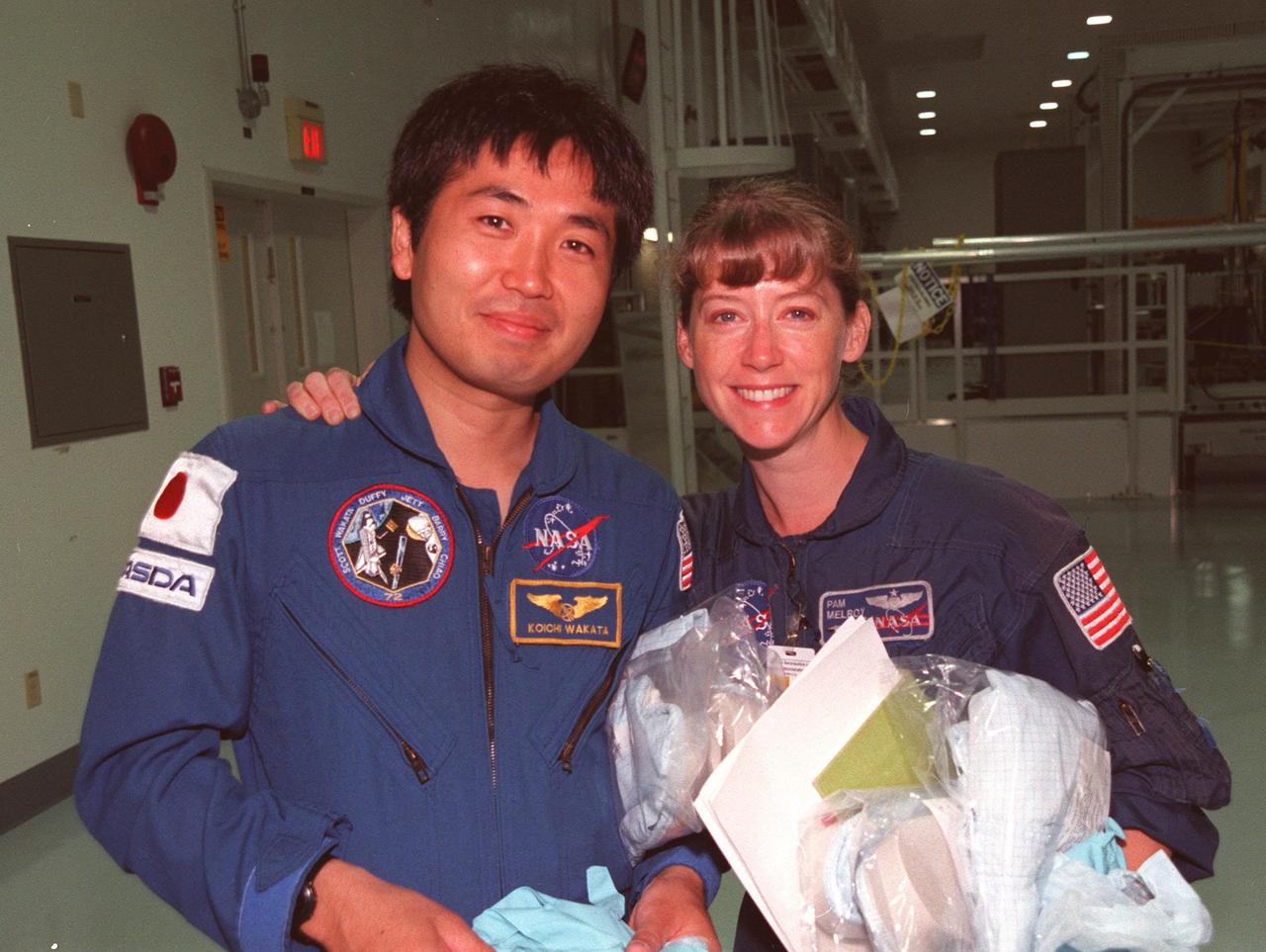 STS-92 Mission Specialist Koichi Wakata, with the National Space Development Agency of Japan (NASDA), and Pilot Pamela A. Melroy take a break during a Leak Seal Kit Fit Check of the Pressurized Mating Adapter -3 in the Space Station Processing Facility. Also participating are the other crew members Commander Brian Duffy and Mission Specialists Leroy Chiao (Ph.D.), Peter J.K. "Jeff" Wisoff (Ph.D.), Michael E. Lopez-Alegria and William Surles "Bill" McArthur Jr. STS-92 is the fourth U.S. flight for construction of the International Space Station. The mission payload also includes an integrated truss structure (Z-1 truss). Launch of STS-92 is scheduled for Feb. 24, 2000