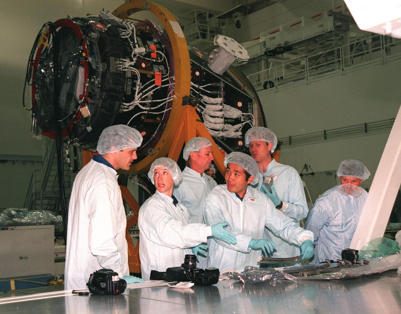 In the Space Station Processing Facility, STS-92 crew members take part in a Leak Seal Kit Fit Check in connection with the Pressurized Mating Adapter -3 in the background. From left are Mission Specialist Peter J.K. "Jeff" Wisoff (Ph.D.), Pilot Pamela A. Melroy, Commander Brian Duffy, Mission Specialist Koichi Wakata, who represents the National Space Development Agency of Japan (NASDA), Brian Warkentine, with JSC, and a Boeing worker at right. Also participating are other crew members Mission Specialists Leroy Chiao (Ph.D.), Michael E. Lopez-Alegria and William Surles "Bill" McArthur Jr. The mission payload also includes an integrated truss structure (Z-1 truss). Launch of STS-92 is scheduled for Feb. 24, 2000