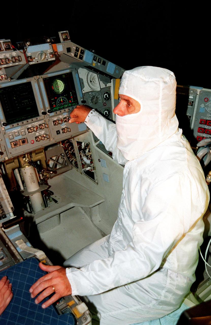 KENNEDY SPACE CENTER, FLA. -- In the cockpit of the orbiter Atlantis, which is in the Orbiter Processing Facility, U.S. Rep. Dave Weldon looks at the newly installed Multifunction Electronic Display Subsystem (MEDS), known as the "glass cockpit." Weldon is on the House Science Committee and vice chairman of the Space and Aeronautics Subcommittee. He was in Palmdale, Calif., when Atlantis underwent the modification and he wanted to see the final product. The full-color, flat-panel MEDS upgrade improves crew/orbiter interaction with easy-to-read, graphic portrayals of key flight indicators like attitude display and mach speed. The installation makes Atlantis the most modern orbiter in the fleet and equals the systems on current commercial jet airliners and military aircraft. Atlantis is scheduled to fly on mission STS-101 in early December