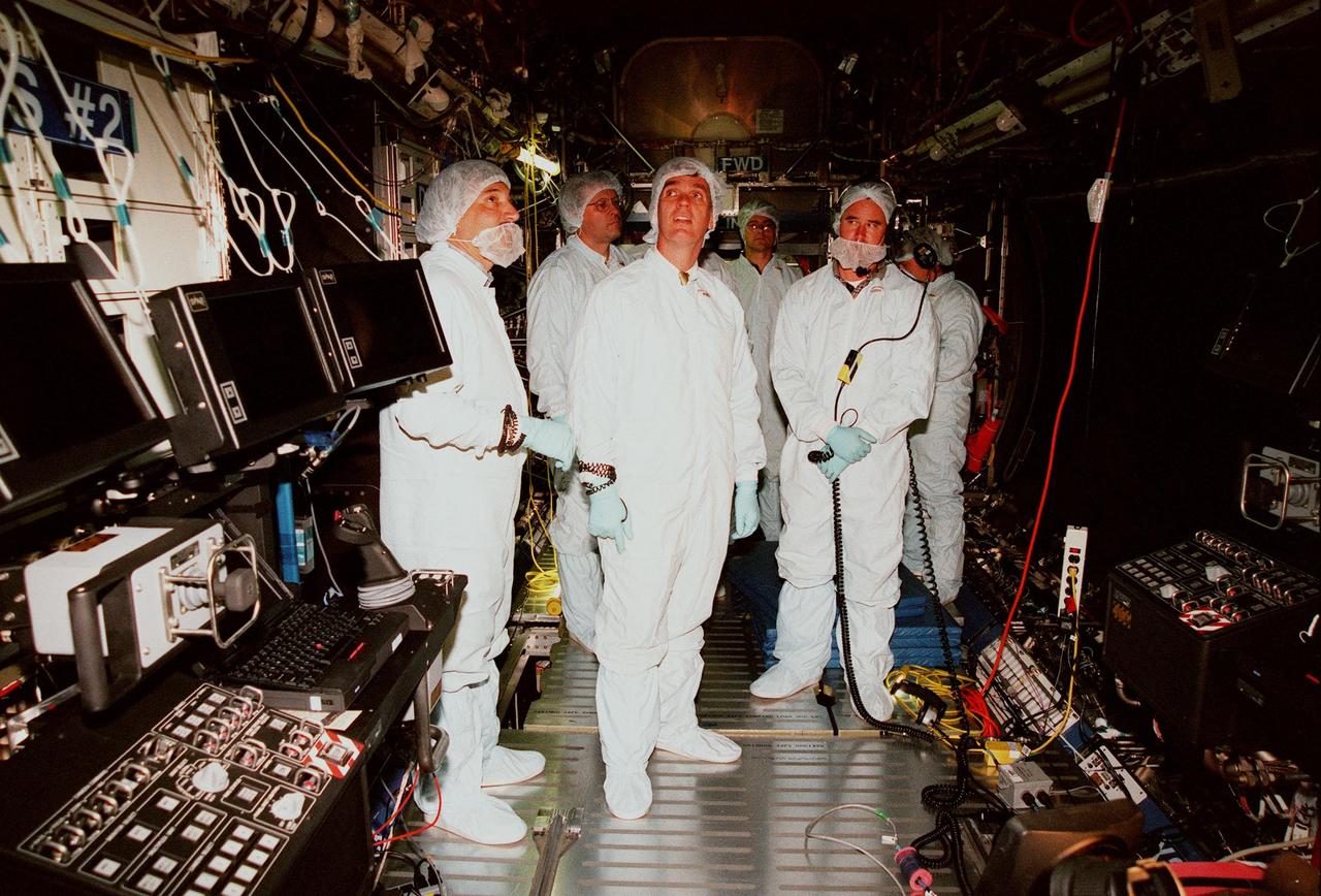KENNEDY SPACE CENTER, FLA. -- In the Space Station Processing Facility, U.S. Rep. Dave Weldon (center) looks over the U.S. Laboratory, called "Destiny," with a group of Boeing workers. Behind (left) the congressman is Dana Gartzke, the congressman's chief of staff. Weldon is on the House Science Committee and vice chairman of the Space and Aeronautics Subcommittee. Destiny, which will become the centerpiece of scientific research on the ISS, will have five equipment racks aboard to provide essential functions for station systems, including high data-rate communications, and to maintain the station's orientation using control gyroscopes launched earlier. Additional equipment and research racks will be installed in the laboratory on subsequent Shuttle flights. Destiny is scheduled to be launched on Space Shuttle Endeavour in early 2000