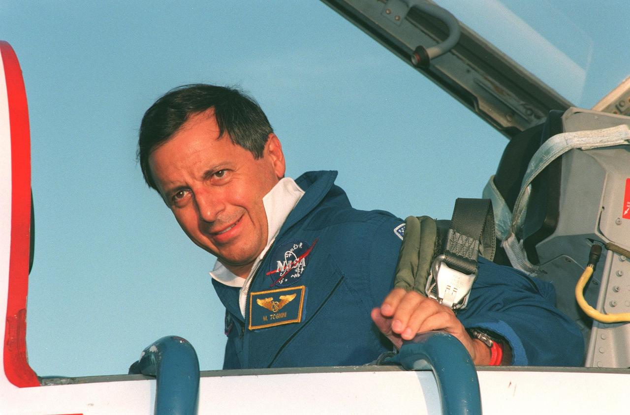 STS-93 Mission Specialist Michel Tognini of France, with the Centre National d'Etudes Spatiales (CNES), prepares to leave the T-38 jet aircraft that brought him to KSC's Shuttle Landing Facility. He and other crew members Commander Eileen Collins, Pilot Jeffrey S. Ashby, and Mission Specialists Steven A. Hawley (Ph.D.) and Catherine G. "Cady" Coleman (Ph.D.) are arriving for pre-launch activities. Tognini is making his inaugural Shuttle flight. The primary mission of STS-93 is the release of the Chandra X-ray Observatory, which will allow scientists from around the world to study some of the most distant, powerful and dynamic objects in the universe. The new telescope is 20 to 50 times more sensitive than any previous X-ray telescope and is expected to unlock the secrets of supernovae, quasars and black holes