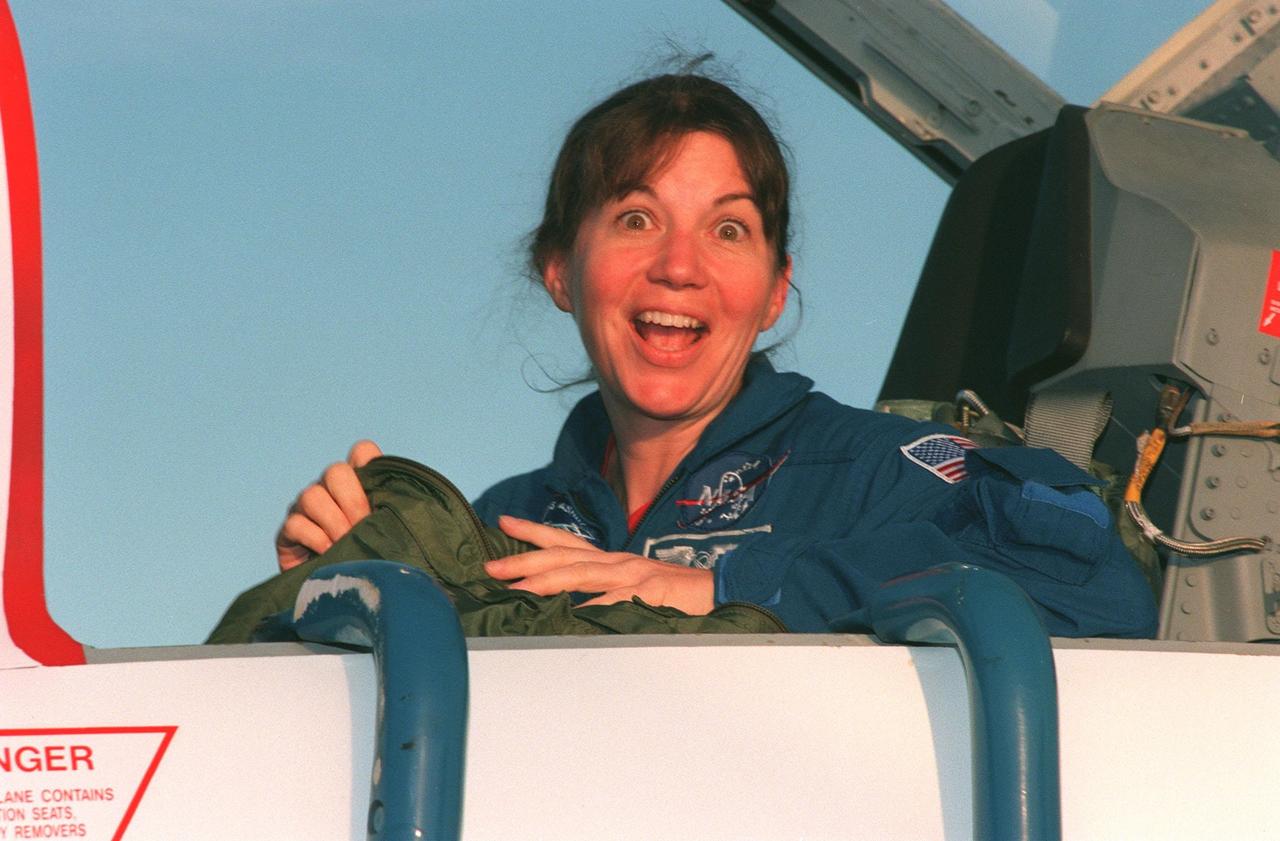 STS-93 Mission Specialist Catherine G. "Cady" Coleman (Ph.D.) shows her sense of humor upon arriving at KSC's Shuttle Landing Facility aboard a T-38 jet aircraft. She and other crew members Commander Eileen Collins, Pilot Jeffrey S. Ashby, and Mission Specialists Steven A. Hawley (Ph.D.) and Michel Tognini of France, with the Centre National d'Etudes Spatiales (CNES), are arriving for pre-launch activities. Coleman is making her second Shuttle flight. The primary mission of STS-93 is the release of the Chandra X-ray Observatory, which will allow scientists from around the world to study some of the most distant, powerful and dynamic objects in the universe. The new telescope is 20 to 50 times more sensitive than any previous X-ray telescope and is expected to unlock the secrets of supernovae, quasars and black holes
