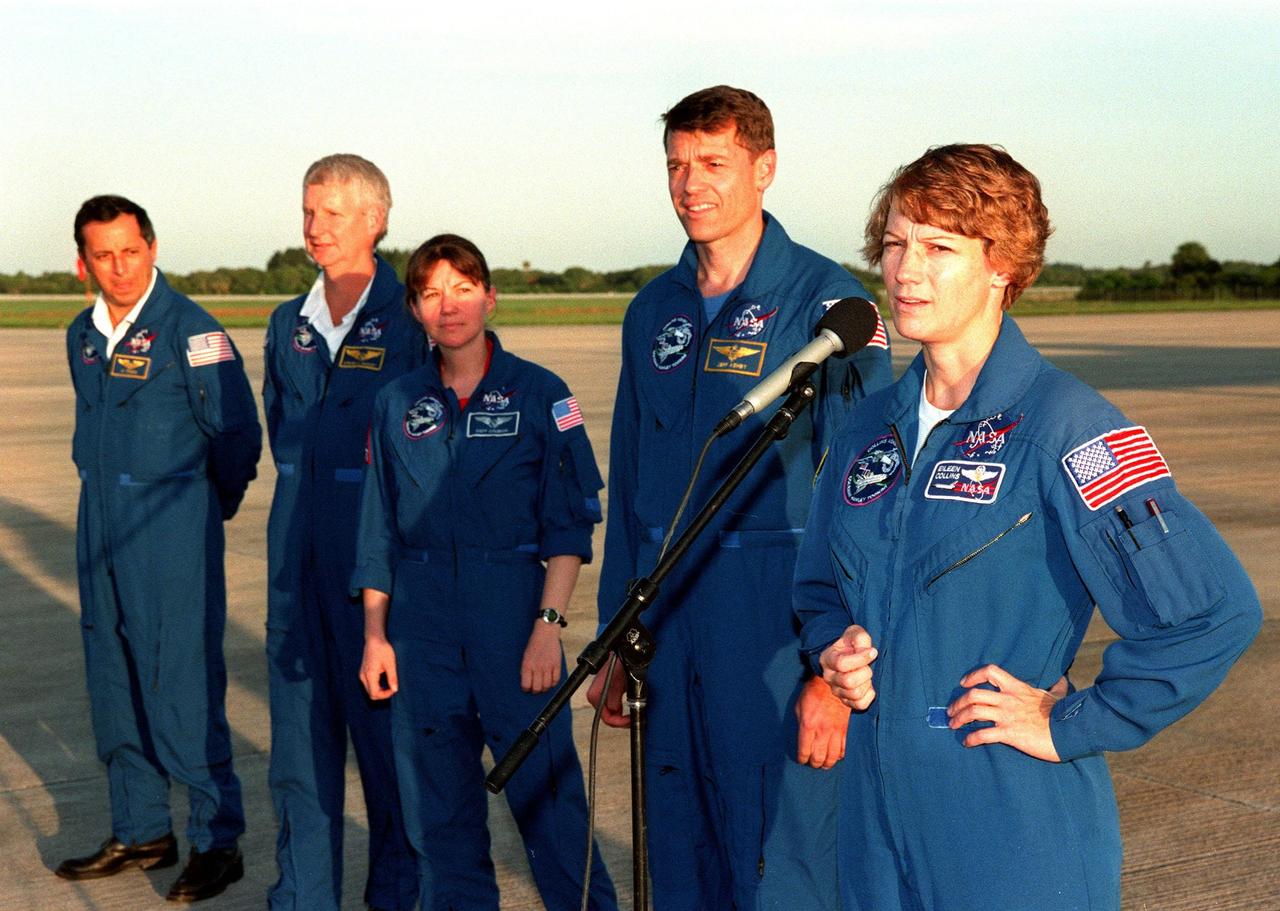 After arrival at KSC's Shuttle Landing Facility, the STS-93 crew speak to the media about their mission. From left are Mission Specialists Michel Tognini of France, who is with the Centre National d'Etudes Spatiales (CNES), Steven A. Hawley (Ph.D.), and Catherine G. "Cady" Coleman (Ph.D.), Pilot Jeffrey S. Ashby, and Commander Eileen M. Collins. Hawley has the most Shuttle flights, this being his fifth. Collins is making her third flight (the first as a commander), Coleman is making her second flight, and Ashby and Tognini are making their first flights. The primary mission of STS-93 is the release of the Chandra X-ray Observatory, which will allow scientists from around the world to study some of the most distant, powerful and dynamic objects in the universe. The new telescope is 20 to 50 times more sensitive than any previous X-ray telescope and is expected to unlock the secrets of supernovae, quasars and black holes