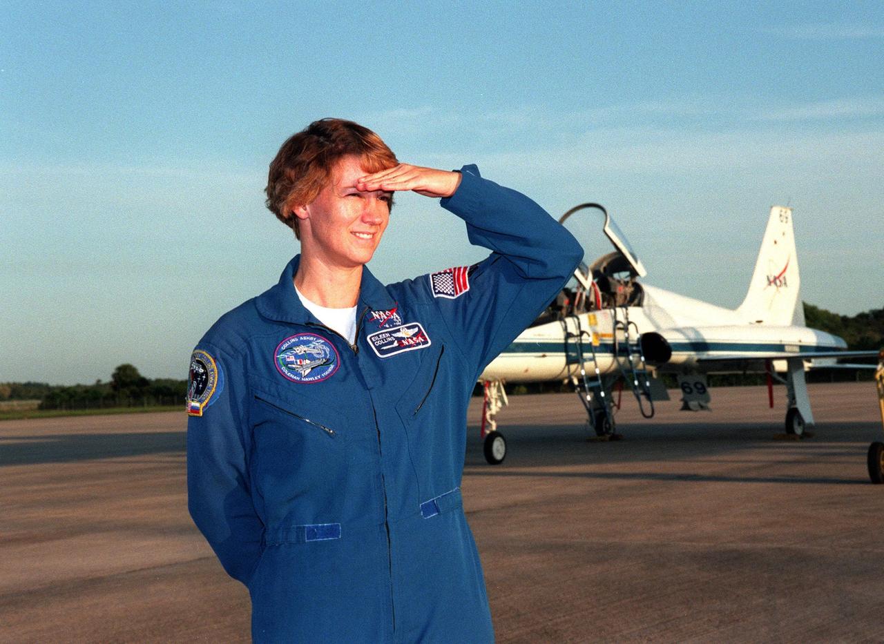 STS-93 Commander Eileen Collins peers into the eastern early morning sky after landing at Kennedy Space Center's Shuttle Landing Facility (SLF) aboard a T-38 jet aircraft (background). She and other crew members Pilot Jeffrey S. Ashby and Mission Specialists Steven A. Hawley (Ph.D.), Catherine G. "Cady" Coleman (Ph.D.) and Michel Tognini of France, with the Centre National d'Etudes Spatiales (CNES), are arriving for pre-launch activities. Collins is the first woman to serve as mission commander. This is her third Shuttle flight. The primary mission of STS-93 is the release of the Chandra X-ray Observatory, which will allow scientists from around the world to study some of the most distant, powerful and dynamic objects in the universe. The new telescope is 20 to 50 times more sensitive than any previous X-ray telescope and is expected to unlock the secrets of supernovae, quasars and black holes