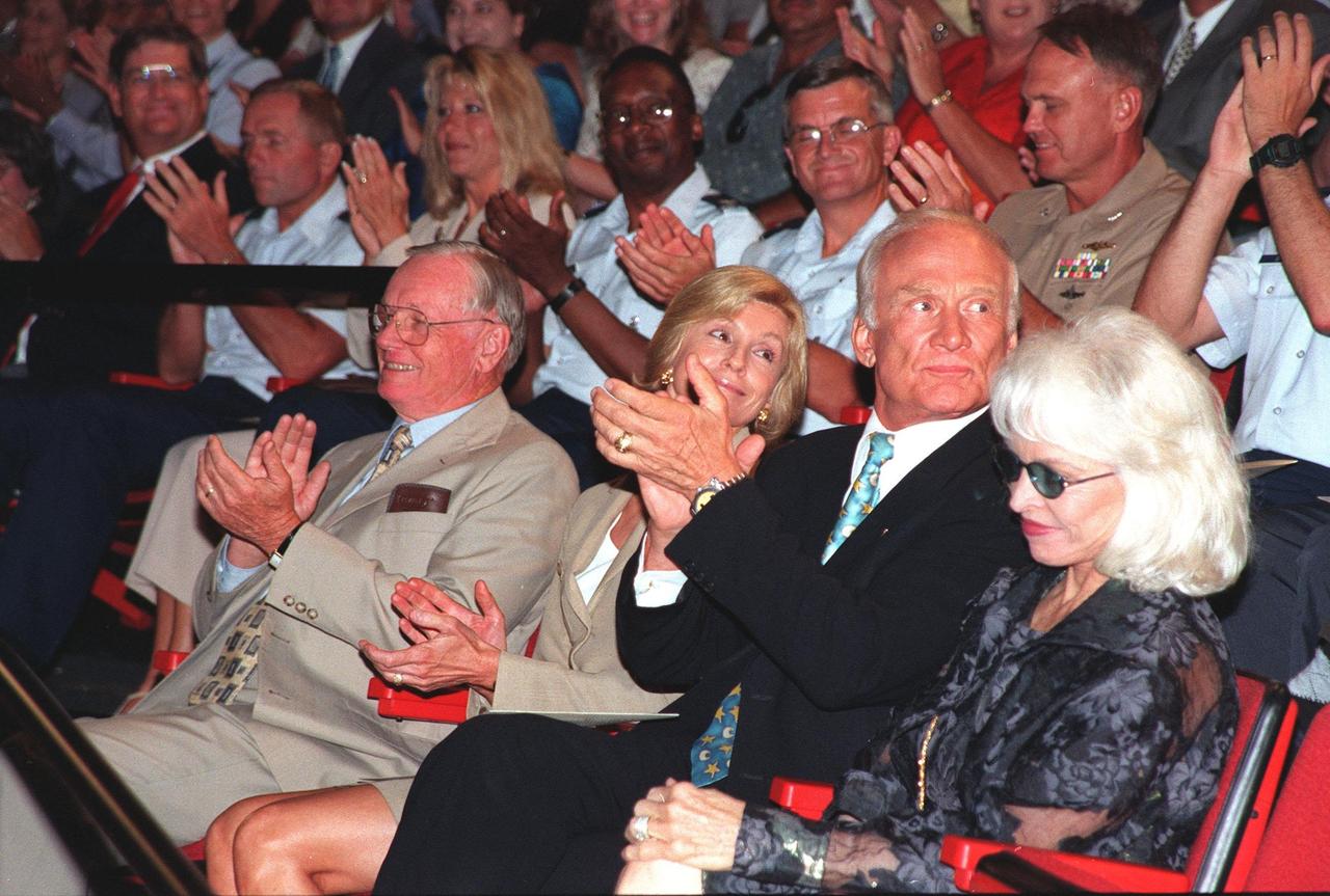 At a special presentation of the Hammer Award in the IMAX 2 Theater in the Kennedy Space Center Visitor Complex, former Apollo astronauts Neil Armstrong (left) and Edwin "Buzz" Aldrin (second from right) applauded the recipients, Kennedy Space Center and the 45th Space Wing. The Hammer Award is Vice President Al Gore's special recognition of teams of federal employees who have made significant contributions in support of the principles of the National Partnership for Reinventing Government. This Hammer Award acknowledges the accomplishments of a joint NASA and Air Force team that established the Joint Base Operations and Support Contract (J-BOSC) Source Evaluation Board (SEB). Ed Gormel and Chris Fairey, co-chairs of the SEB, accepted the awards for the SEB. The team developed and implemented the acquisition strategy for establishing a single set of base operations and support service requirements for KSC, Cape Canaveral Air Station and Patrick Air Force Base. Armstrong and Aldrin were at KSC to attend a banquet and other activities for the 30th anniversary of the Apollo 11 mission, which landed the first man on the moon