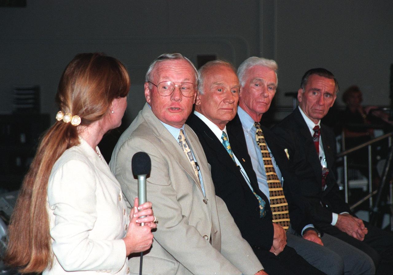 KENNEDY SPACE CENTER, FLA. -- In the Apollo/Saturn V Center, Lisa Malone (left), chief of KSC's Media Services branch, relays a question from the media to former Apollo astronaut Neil A. Armstrong. Beside Armstrong are Edwin "Buzz" Aldrin, Gene Cernan, and Walt Cunningham, all of whom also flew on Apollo missions. The four met with the media prior to an anniversary banquet highlighting the contributions of aerospace employees who made the Apollo program possible. The banquet celebrated the 30th anniversary of the launch and moon landing, July 16 and July 20, 1969. Neil Armstrong was the first man to set foot on the moon
