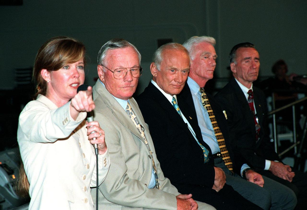 KENNEDY SPACE CENTER, FLA. -- In the Apollo/Saturn V Center, Lisa Malone (left), chief of KSC's Media Services branch, identifies a reporter to pose a question to one of the former Apollo astronauts seated next to her. From left, they are Neil A. Armstrong and Edwin "Buzz" Aldrin who flew on Apollo 11, the launch to the moon; Gene Cernan, who flew on Apollo 10 and 17; and Walt Cunningham, who flew on Apollo 7. This is the 30th anniversary of the launch and moon landing, July 16 and July 20, 1969. Neil Armstrong was the first man to set foot on the moon