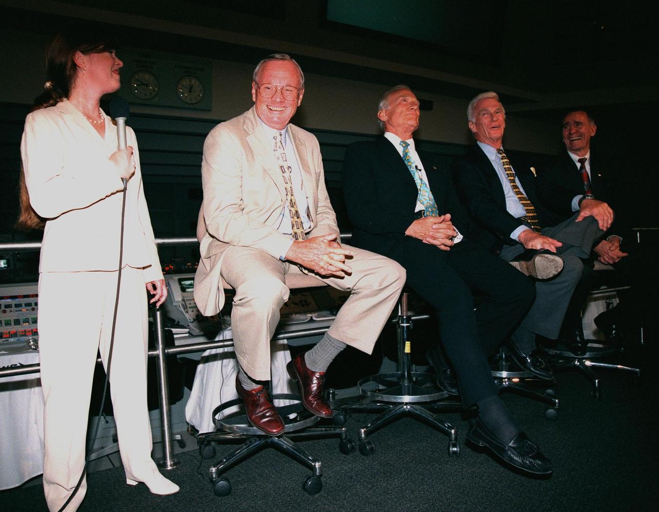 KENNEDY SPACE CENTER, FLA. -- In the Apollo/Saturn V Center, Lisa Malone (left), chief of KSC's Media Services branch, laughs at a humorous comment along with former Apollo astronauts Neil A. Armstrong and Edwin "Buzz" Aldrin who flew on Apollo 11, the launch to the moon; Gene Cernan, who flew on Apollo 10 and 17; and Walt Cunningham, who flew on Apollo 7. The four met with the media before an anniversary banquet celebrating the accomplishments of the Apollo program team. This is the 30th anniversary of the launch and moon landing, July 16 and July 20, 1969. Neil Armstrong was the first man to set foot on the moon