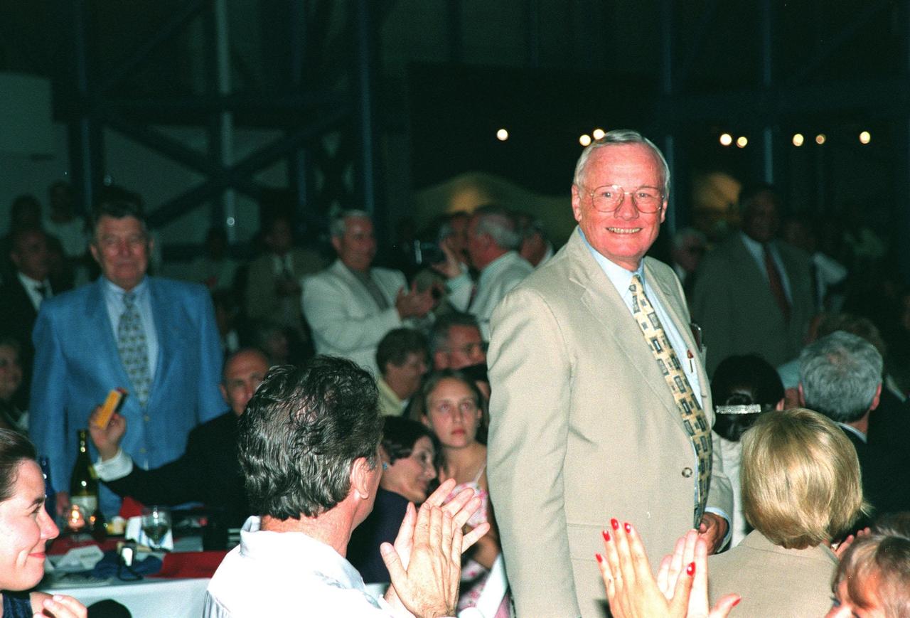 KENNEDY SPACE CENTER, FLA. -- Former Apollo 11 astronaut Neil A. Armstrong stands to a round of applause after being introduced at the anniversary banquet honoring the Apollo team, the people who made the entire lunar landing program possible. The banquet was held in the Apollo/Saturn V Center, part of the KSC Visitor Complex. This is the 30th anniversary of the Apollo 11 launch and moon landing, July 16 and July 20, 1969. Neil Armstrong was the first man to set foot on the moon. He appeared at the banquet with other former astronauts Edwin "Buzz" Aldrin, Gene Cernan, Walt Cunningham and others