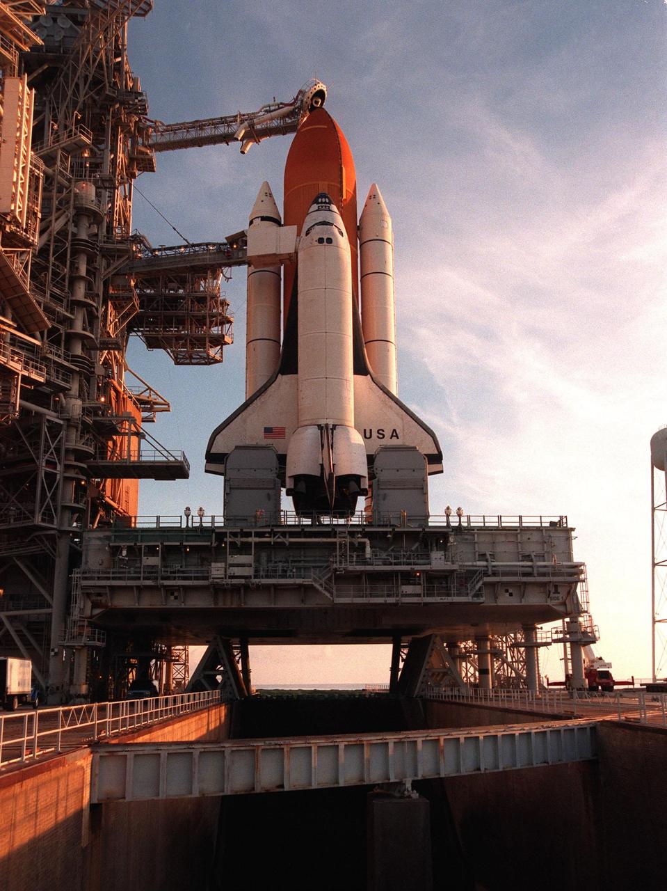 Space Shuttle Columbia, sitting on its mobile launcher platform, is framed against the early morning sky after the rollback of the Rotating Service Structure on Launch Pad 39-B. Columbia waits for the launch of mission STS-93 July 20 at 12:36 a.m. EDT. The primary payload of STS-93 is the Chandra X-ray Observatory, which will allow scientists from around the world to study some of the most distant, powerful and dynamic objects in the universe. The new telescope is 20 to 50 times more sensitive than any previous X-ray telescope and is expected unlock the secrets of supernovae, quasars and black holes. The STS-93 crew numbers five: Commander Eileen M. Collins, Pilot Jeffrey S. Ashby, and Mission Specialists Steven A. Hawley (Ph.D.), Catherine G. Coleman (Ph.D.) and Michel Tognini of France, with the Centre National d'Etudes Spatiales (CNES). Collins is the first woman to serve as commander of a shuttle mission