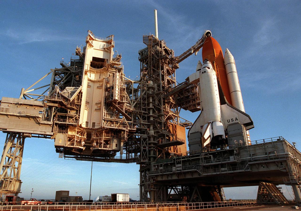 The rollback of the Rotating Service Structure on launch Pad 39-B reveals Space Shuttle Columbia on its mobile launcher platform, waiting for the launch of mission STS-93 on July 20 at 12:36 a.m. EDT. The primary payload of STS-93 is the Chandra X-ray Observatory, which will allow scientists from around the world to study some of the most distant, powerful and dynamic objects in the universe. The new telescope is 20 to 50 times more sensitive than any previous X-ray telescope and is expected unlock the secrets of supernovae, quasars and black holes. The STS-93 crew numbers five: Commander Eileen M. Collins, Pilot Jeffrey S. Ashby, and Mission Specialists Steven A. Hawley (Ph.D.), Catherine G. Coleman (Ph.D.) and Michel Tognini of France, with the Centre National d'Etudes Spatiales (CNES). Collins is the first woman to serve as commander of a shuttle mission