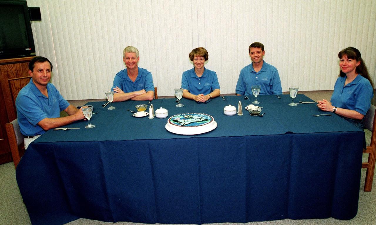 The STS-93 crew gathers for breakfast in the Operations and Checkout Building before suiting up for launch. Space Shuttle Columbia is due to launch Tuesday, July 20, at 12:36 a.m. EDT. Seated from left are Mission Specialists Michel Tognini, of France, who represents the Centre National d'Etudes Spatiales (CNES), and Steven A. Hawley (Ph.D.), Commander Eileen M. Collins, Pilot Jeffrey S. Ashby, and Mission Specialist Catherine G. Coleman (Ph.D.). STS-93 is a five-day mission primarily to release the Chandra X-ray Observatory, which will allow scientists from around the world to study some of the most distant, powerful and dynamic objects in the universe. The new telescope is 20 to 50 times more sensitive than any previous X-ray telescope and is expected unlock the secrets of supernovae, quasars and black holes. Collins is the first woman to serve as commander of a Shuttle mission