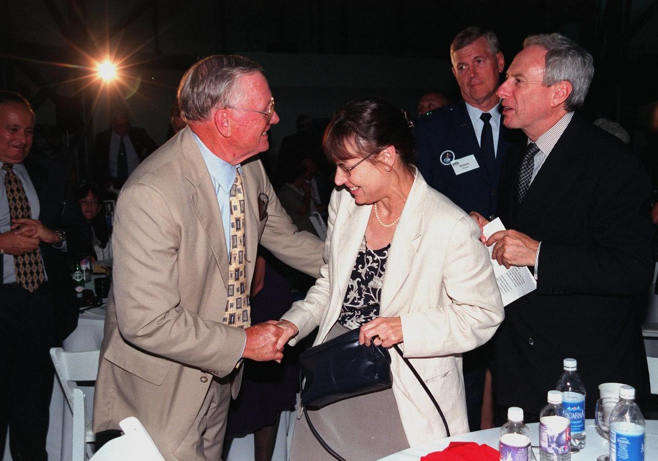 KENNEDY SPACE CENTER, FLA. -- During an anniversary banquet honoring the Apollo team, the people who made the entire lunar landing program possible, former Apollo astronaut Neil A. Armstrong (left) shakes the hand of Judy Goldin (center), wife of NASA Administrator Daniel S. Goldin (right). The banquet was held in the Apollo/Saturn V Center, part of the KSC Visitor Complex. This is the 30th anniversary of the Apollo 11 launch and moon landing, July 16 and July 20, 1969. Among the guests at the banquet were former Apollo astronauts are Neil A. Armstrong and Edwin "Buzz" Aldrin who flew on Apollo 11, the launch of the first moon landing; Gene Cernan, who flew on Apollo 10 and 17 and was the last man to walk on the moon; and Walt Cunningham, who flew on Apollo 7