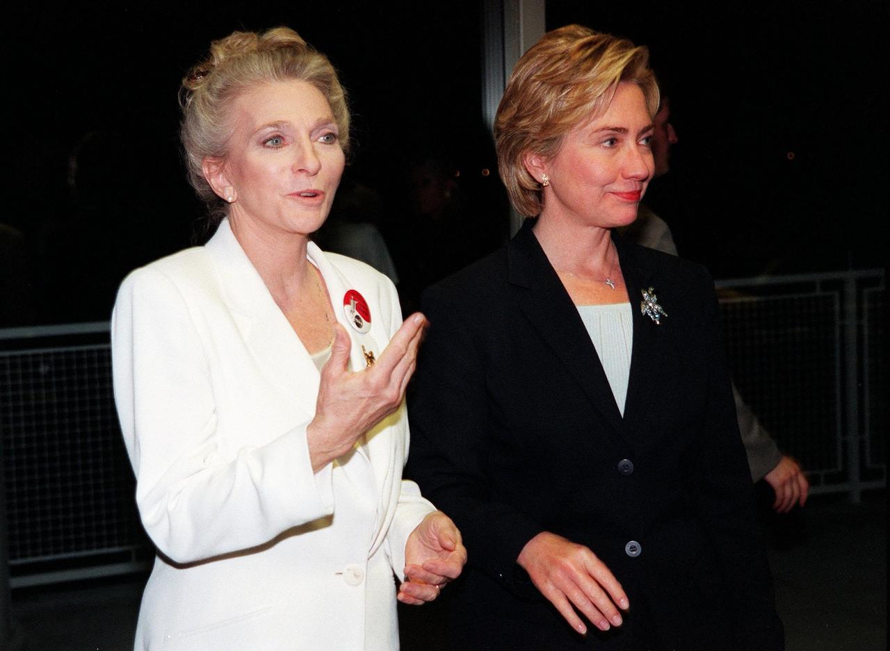 KENNEDY SPACE CENTER, FLA. -- Singer Judy Collins (left) and First Lady Hillary Rodham Clinton await the launch of Space Shuttle mission STS-93 in the Apollo/Saturn V Facility. Liftoff is scheduled for 12:36 a.m. EDT July 20. Much attention has been generated over the launch due to Commander Eileen M. Collins, the first woman to serve as commander of a Shuttle mission. Judy Collins has honored the commander with a song, "Beyond the Sky," which was commissioned by NASA through the NASA Art Program