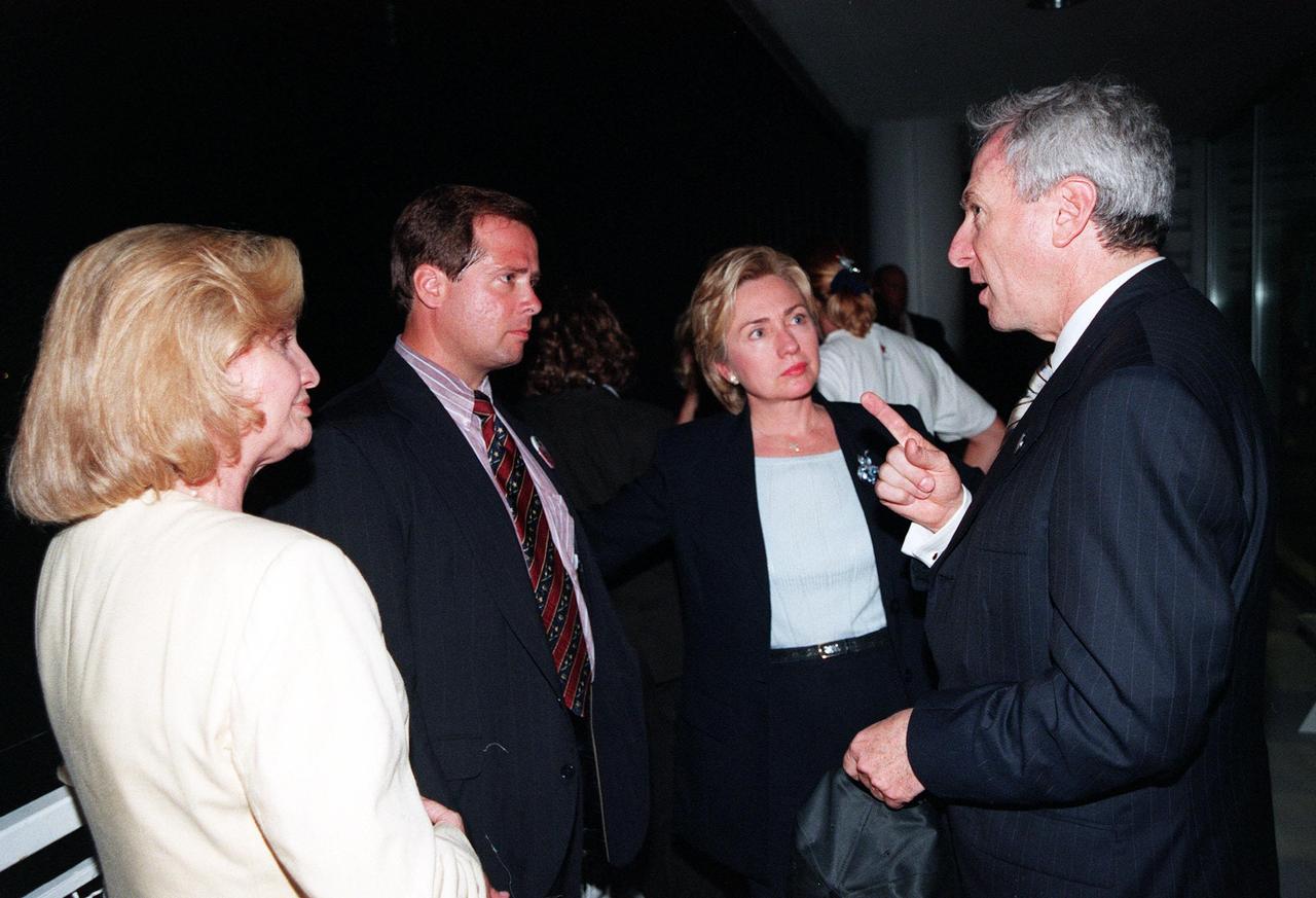 KENNEDY SPACE CENTER, FLA. -- At the Apollo/Saturn V Center, NASA Administrator Daniel Goldin (right) chats with First Lady Hillary Rodham Clinton and others while waiting for the launch of STS-93. Much attention has been generated over STS-93 due to Commander Eileen M. Collins, the first woman to serve as commander of a Shuttle mission. The primary payload of the five-day mission is the Chandra X-ray Observatory, which will allow scientists from around the world to study some of the most distant, powerful and dynamic objects in the universe. The new telescope is 20 to 50 times more sensitive than any previous X-ray telescope and is expected to unlock the secrets of supernovae, quasars and black holes. Liftoff of Space Shuttle Columbia is scheduled for 12:36 a.m. EDT July 20