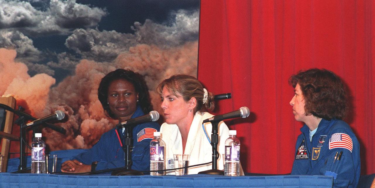 KENNEDY SPACE CENTER, FLA. -- Astronaut Yvonne Cagle (left); Jennifer Harris (center); the Mars 2001 Operations System Development Manager at the Jet Propulsion Laboratory; and Astronaut Ellen Ochoa (right) participate in a panel about "Past, Present and Future of Space," held at a women's forum in the Apollo/Saturn V Center. The forum included a welcome by Center Director Roy Bridges and remarks by Donna Shalala, secretary of Department of Health and Human Services. The attendees are planning to view the launch of STS-93 at the Banana Creek viewing site. Much attention has been generated over the launch due to Commander Eileen M. Collins, the first woman to serve as commander of a Shuttle mission. The primary payload of the five-day mission is the Chandra X-ray Observatory, which will allow scientists from around the world to study some of the most distant, powerful and dynamic objects in the universe. Liftoff is scheduled for July 20 at 12:36 a.m. EDT