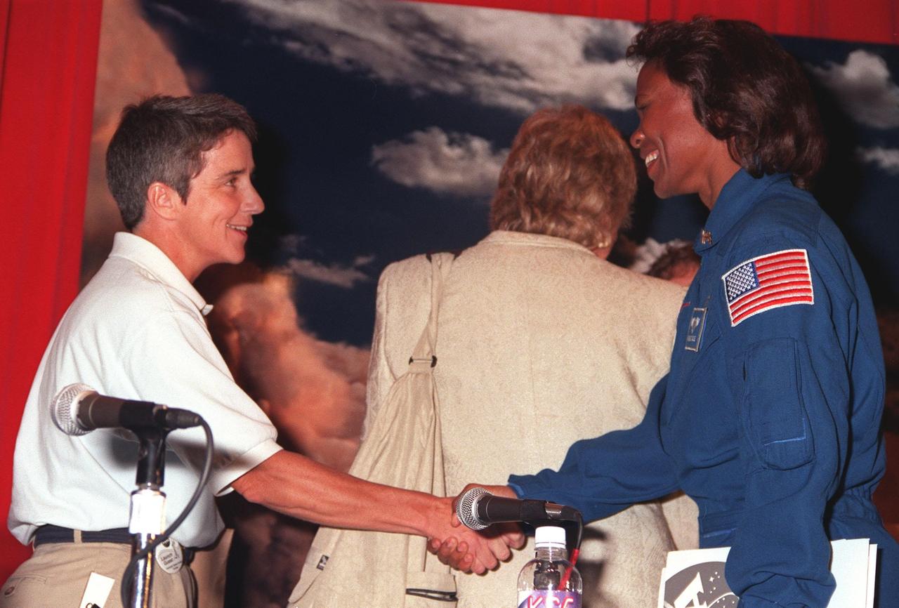 KENNEDY SPACE CENTER, Fla. -- At a women's forum held in the Apollo/Saturn V Center, Marta Bohn-Meyer, the first woman to pilot an SR-71, greets astronaut Yvonne Cagle. They participated in the panel discussion about "Past, Present and Future of Space," along with Kathryn Sullivan, Ph.D., the first American woman to walk in space; Donna Shirley, Ph.D., the first woman leading the Mars Exploration Program; Jennifer Harris, the Mars 2001 Operations System Development Manager at the Jet Propulsion Laboratory; and astronaut Ellen Ochoa, the first Hispanic female in space and member of the President's commission on the Celebration of Women in American History. The forum included a welcome by Center Director Roy Bridges and remarks by Donna Shalala, secretary of Department of Health and Human Services. The attendees are planning to view the launch of STS-93 at the Banana Creek viewing site. Much attention has been generated over the launch due to Commander Eileen M. Collins, the first woman to serve as commander of a Shuttle mission. The primary payload of the five-day mission is the Chandra X-ray Observatory, which will allow scientists from around the world to study some of the most distant, powerful and dynamic objects in the universe. Liftoff is scheduled for July 20 at 12:36 a.m. EDT