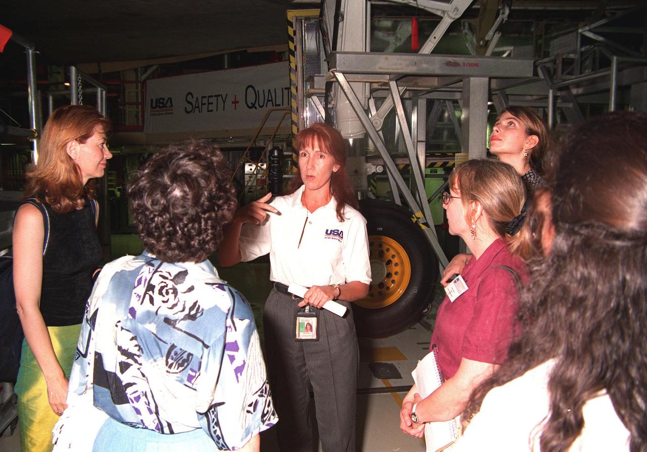 Attendees of a women's forum held at the Apollo/Saturn V Center, get a guided tour of the Orbiter Processing Facility and a closeup look at an orbiter overhead. The forum included a welcome by Center Director Roy Bridges, remarks by NASA Administrator Daniel Goldin, and a panel discussion, "Past, Present and Future of Space." The attendees are planning to view the launch of STS-93 at the Banana Creek viewing sight. Much attention has been generated over the launch due to Commander Eileen M. Collins, the first woman to serve as commander of a Shuttle mission. The primary payload of the five-day mission is the Chandra X-ray Observatory, which will allow scientists from around the world to study some of the most distant, powerful and dynamic objects in the universe. Liftoff is scheduled for July 20 at 12:36 a.m. EDT