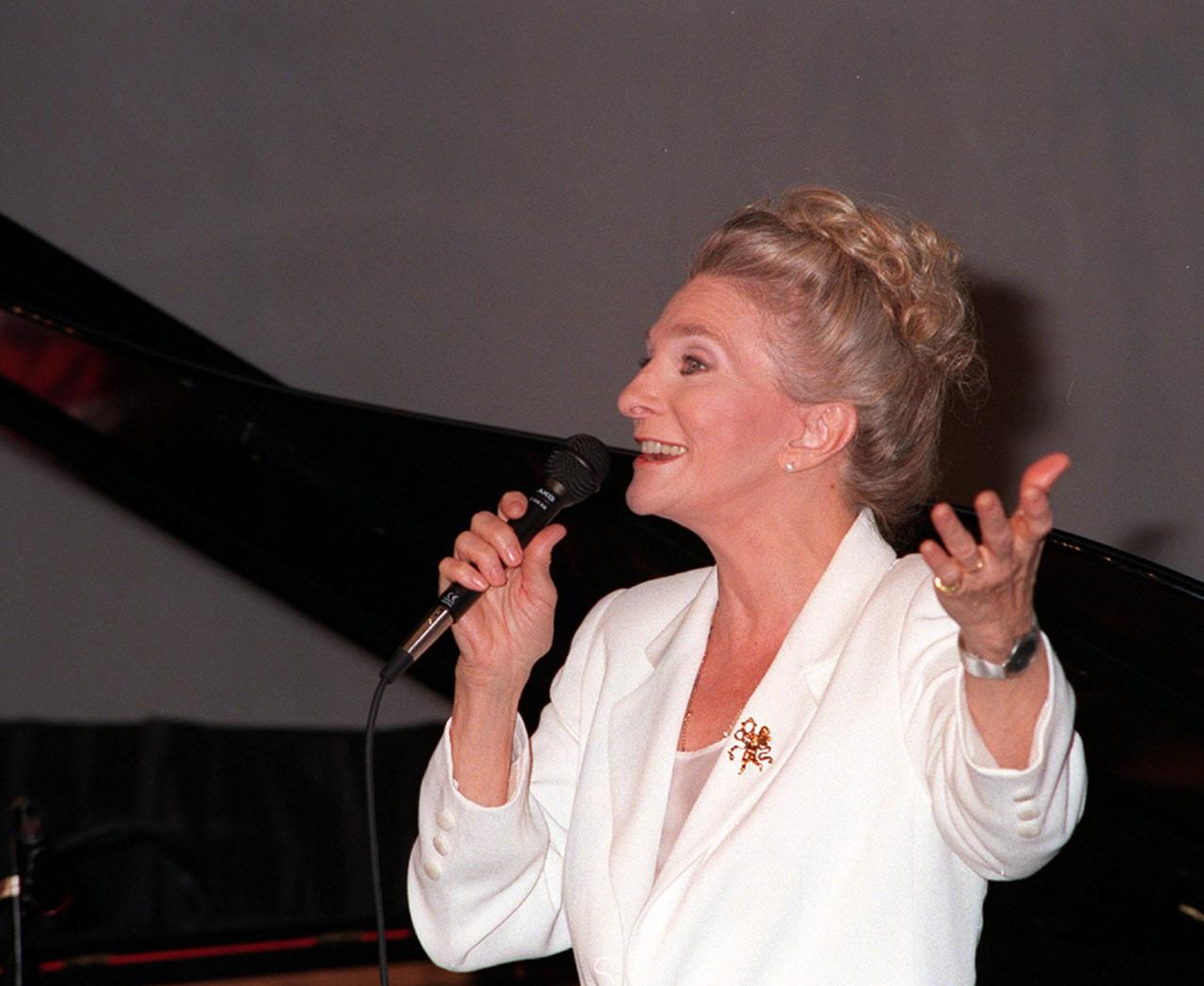 Singer-songwriter Judy Collins performs her original song, "Beyond the Sky," at the KSC Visitor Complex's Imax Theater for an audience of women attending a forum. The song, commissioned by NASA through the nASA Art Program, honored Eileen Collins, the first woman to command a Space Shuttle. The forum included a welcome by Center Director Roy Bridges, remarks by NASA Administrator Daniel Goldin, and a panel discussion, "Past, Present and Future of Space." The attendees are planning to view the launch of STS-93 at the Banana Creek viewing sight. Liftoff is scheduled for July 20 at 12:36 a.m. EDT