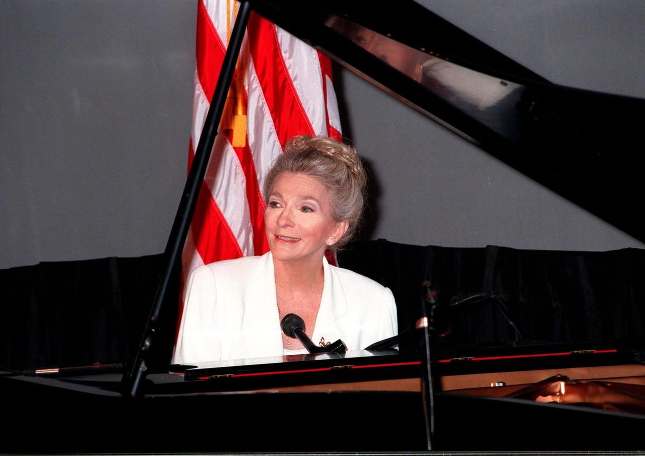 Singer-songwriter Judy Collins performs her original song, "Beyond the Sky," at the KSC Visitor Complex's Imax Theater for an audience waiting for the launch of STS-93. The song, commissioned by NASA through the nASA Art Program, honored Eileen Collins, the first woman to command a Space Shuttle. The attendees are planning to view the launch at the Banana Creek viewing sight. Liftoff is scheduled for July 20 at 12:36 a.m. EDT