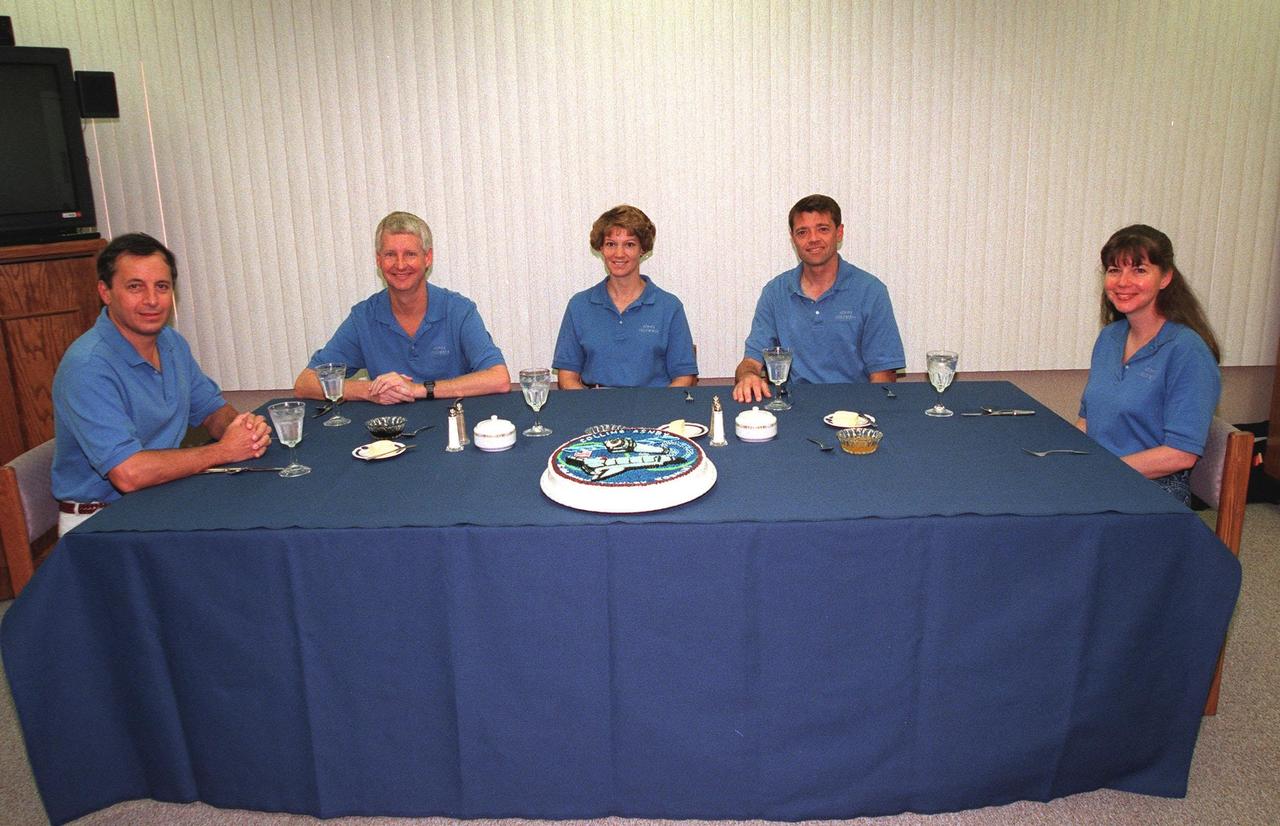 The STS-93 crew gathers a second time for a pre-launch breakfast in the Operations and Checkout Building before suiting up for launch. After Space Shuttle Columbia's July 20 launch attempt was scrubbed at the T-7 second mark in the countdown, the launch was rescheduled for Thursday, July 22, at 12:28 a.m. EDT. Seated from left are Mission Specialists Michel Tognini, of France, who represents the Centre National d'Etudes Spatiales (CNES), and Steven A. Hawley (Ph.D.), Commander Eileen M. Collins, Pilot Jeffrey S. Ashby, and Mission Specialist Catherine G. Coleman (Ph.D.). STS-93 is a five-day mission primarily to release the Chandra X-ray Observatory, which will allow scientists from around the world to study some of the most distant, powerful and dynamic objects in the universe. The new telescope is 20 to 50 times more sensitive than any previous X-ray telescope and is expected unlock the secrets of supernovae, quasars and black holes. Collins is the first woman to serve as commander of a Shuttle mission. The target landing date is July 26, 1999, at 11:24 p.m. EDT