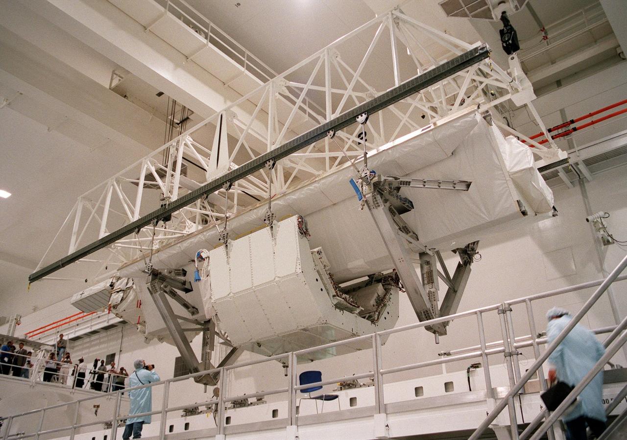 KENNEDY SPACE CENTER, FLA. -- In the Space Station Processing Facility, the Shuttle Radar Topography Mission (SRTM) is lifted for its move to a payload bay canister on the floor. The canister will then be moved to the Orbiter Processing Facility and placed in the bay of the orbiter Endeavour. The SRTM consists of a specially modified radar system that will gather data for the most accurate and complete topographic map of the Earth's surface that has ever been assembled. SRTM will make use of radar interferometry, wherein two radar images are taken from slightly different locations. Differences between these images allow for the calculation of surface elevation, or change. The SRTM hardware will consist of one radar antenna in the shuttle payload bay and a second radar antenna attached to the end of a mast extended 60 meters (195 feet) out from the shuttle. STS-99 is scheduled to launch Sept. 16 at 8:47 a.m. from Launch Pad 39A