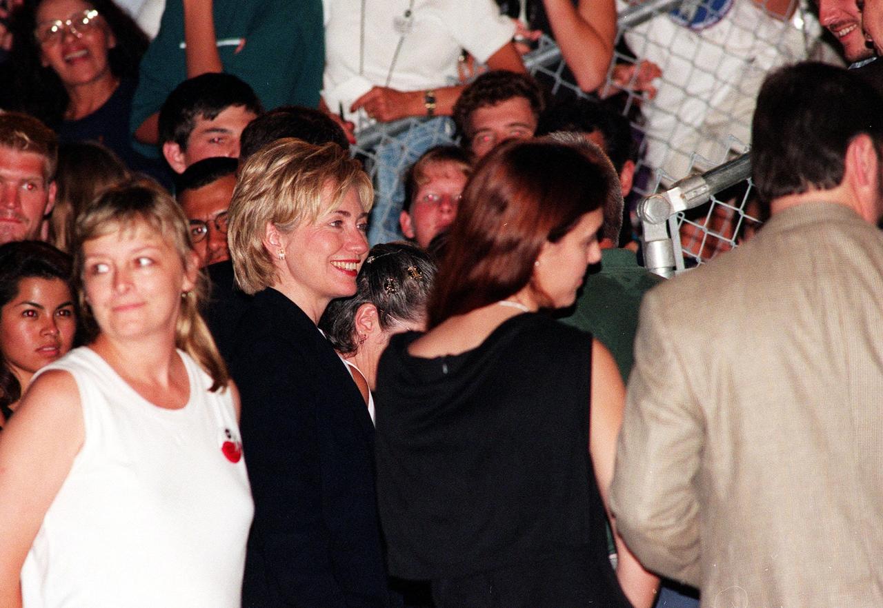 First Lady Hillary Rodham Clinton joins other VIPs at the Banana Creek viewing site to watch the launch of STS-93, the second attempt. Moments before the first scheduled launch, July 20, STS-93 was scrubbed at the T-7 second mark in the countdown due to an indication of a high concentration of hydrogen in an aft engine compartment. The reading proved to be a false alarm. The launch was rescheduled for July 22 at 12:28 a.m. Much attention has been generated over STS-93 due to Commander Eileen M. Collins, the first woman to serve as commander of a Shuttle mission. The primary payload of the five-day mission is the Chandra X-ray Observatory, which will allow scientists from around the world to study some of the most distant, powerful and dynamic objects in the universe