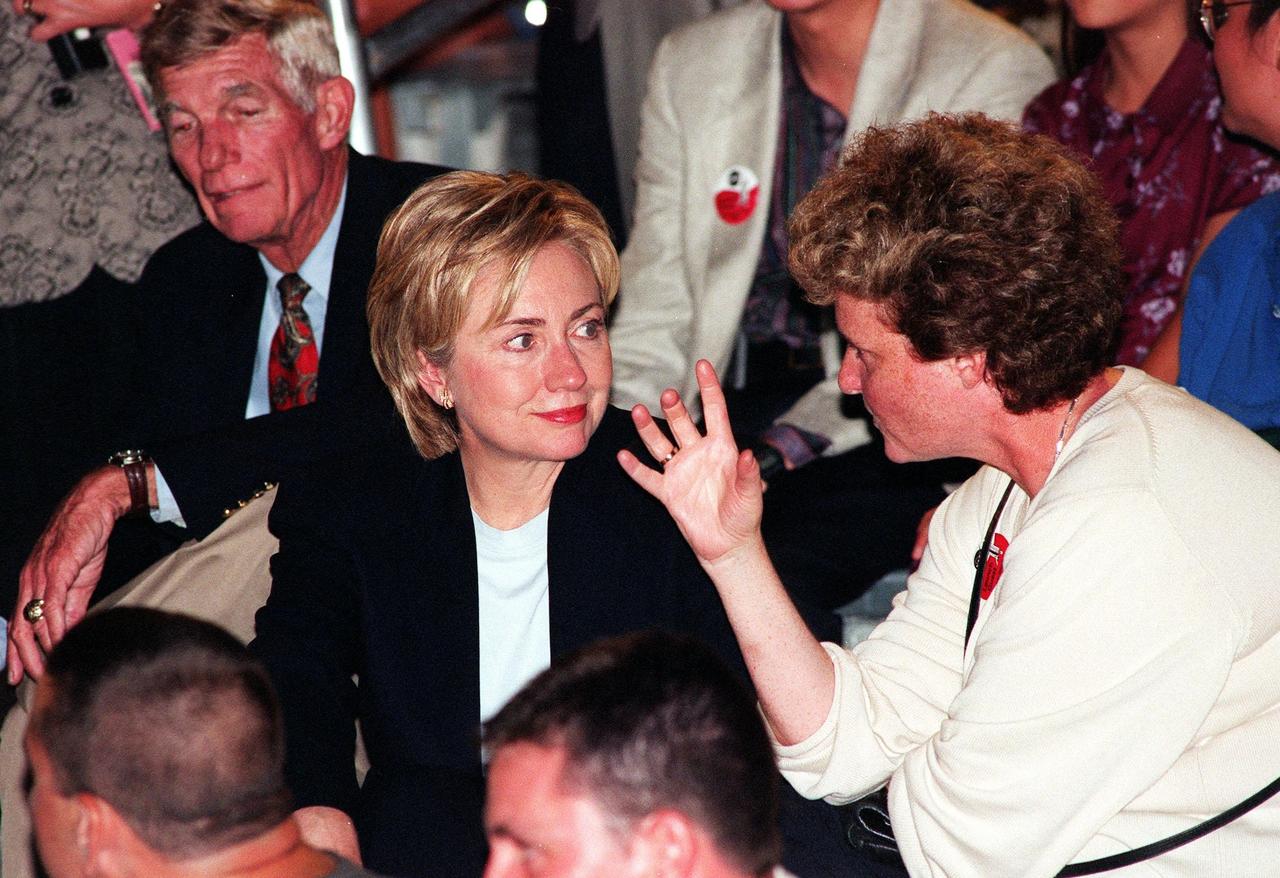 Seated in the Banana Creek viewing site, First Lady Hillary Rodham Clinton appears attentive to the conversation of a fellow spectator. Mrs. Clinton and others are gathered to watch the second launch attempt of STS-93. Moments before the first scheduled launch, July 20, STS-93 was scrubbed at the T-7 second mark in the countdown due to an indication of a high concentration of hydrogen in an aft engine compartment. The reading proved to be a false alarm. The launch was rescheduled for July 22 at 12:28 a.m. Much attention has been generated over STS-93 due to Commander Eileen M. Collins, the first woman to serve as commander of a Shuttle mission. The primary payload of the five-day mission is the Chandra X-ray Observatory, which will allow scientists from around the world to study some of the most distant, powerful and dynamic objects in the universe
