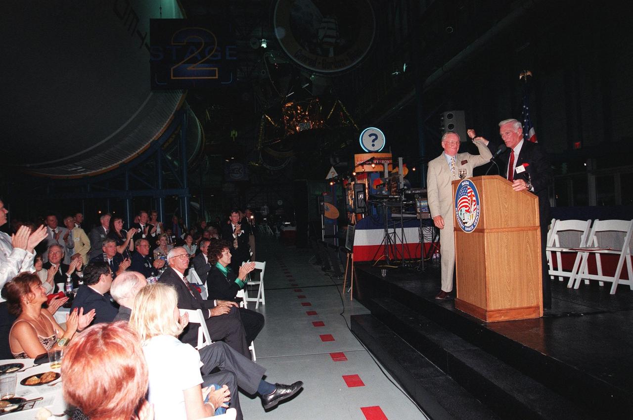 KENNEDY SPACE CENTER, FLA. -- Former Apollo astronauts Neil Armstrong (left) and Gene Cernan entertain the audience during an anniversary banquet honoring the Apollo program team, the people who made the entire lunar landing program possible. The banquet was held in the Apollo/Saturn V Center, part of the KSC Visitor Complex. This is the 30th anniversary of the Apollo 11 launch and moon landing, July 16 and July 20, 1969. Other guests at the banquet were astronauts Wally Schirra, Edwin "Buzz" Aldrin and Walt Cunningham. Armstrong was the first man to walk on the moon; Cernan was the last