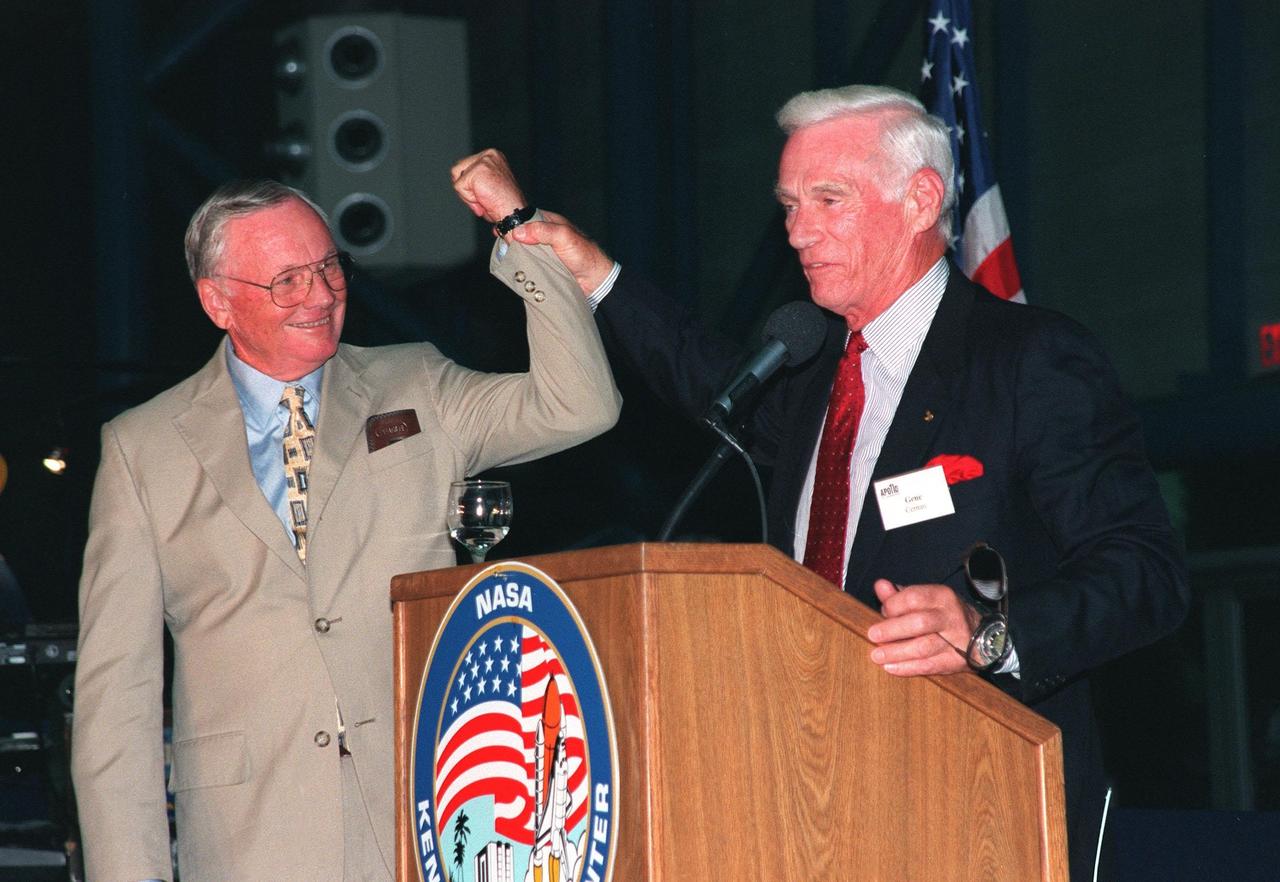 KENNEDY SPACE CENTER, FLA. -- Former Apollo astronauts Neil Armstrong (left) and Gene Cernan entertain the audience during an anniversary banquet honoring the Apollo program team, the people who made the entire lunar landing program possible. The banquet was held in the Apollo/Saturn V Center, part of the KSC Visitor Complex. This is the 30th anniversary of the Apollo 11 launch and moon landing, July 16 and July 20, 1969. Other guests at the banquet were astronauts Wally Schirra, Edwin "Buzz" Aldrin and Walt Cunningham. Neil Armstrong was the first man to walk on the moon; Gene Cernan was the last