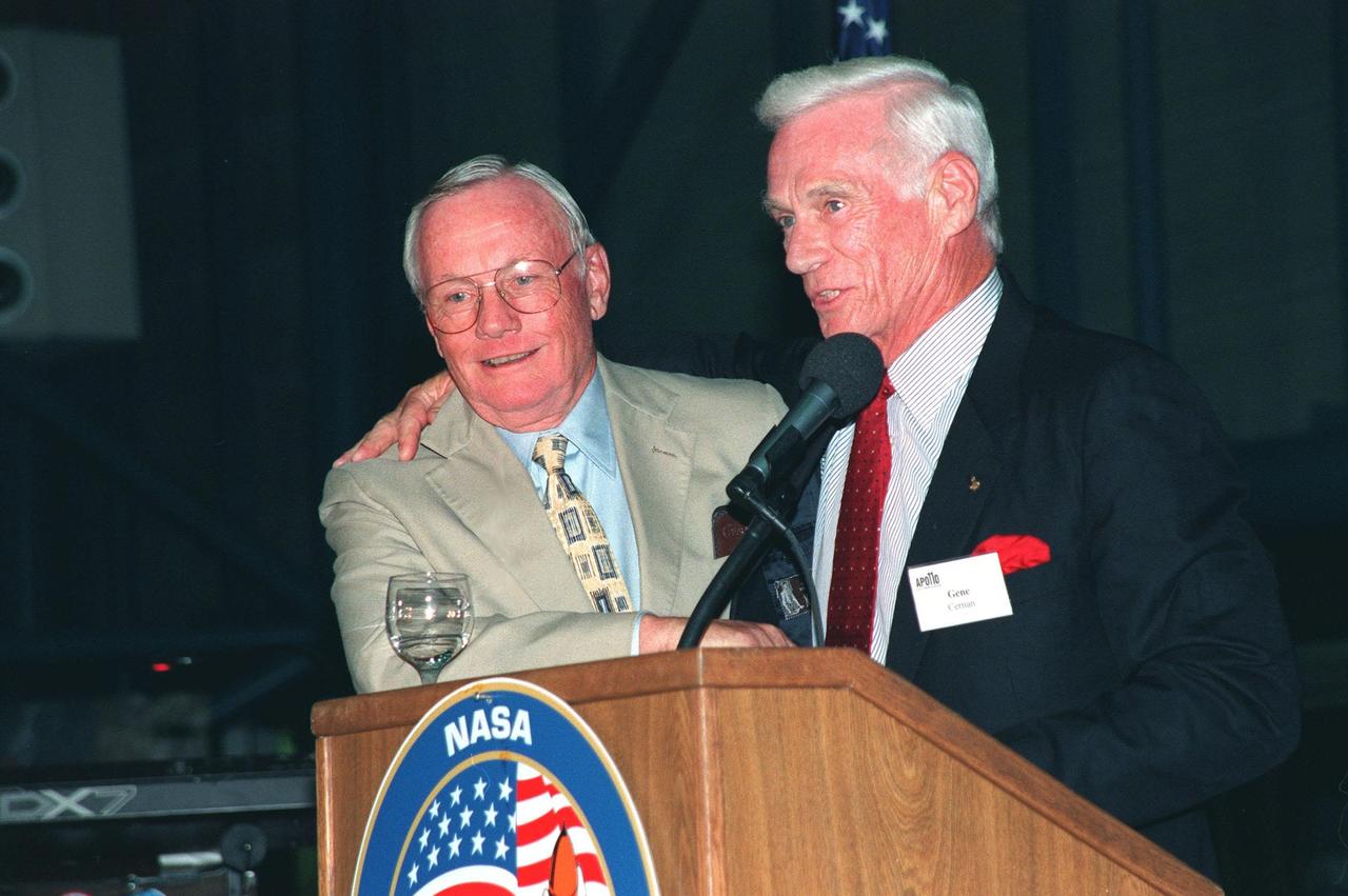 KENNEDY SPACE CENTER, FLA. -- During an anniversary banquet honoring the Apollo program team, the people who made the entire lunar landing program possible, former Apollo astronauts Neil Armstrong (left) and Gene Cernan talk about their experiences. The banquet was held in the Apollo/Saturn V Center, part of the KSC Visitor Complex. This is the 30th anniversary of the Apollo 11 launch and moon landing, July 16 and July 20, 1969. Other guests at the banquet were astronauts Wally Schirra, Edwin "Buzz" Aldrin and Walt Cunningham. Neil Armstrong was the first man to walk on the moon; Gene Cernan was the last